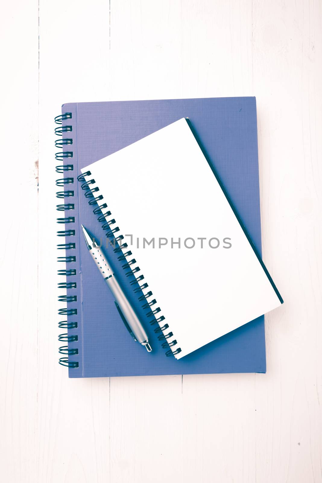 notebook and pen over white table vintage style