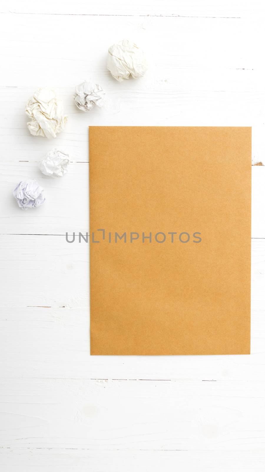 brown paper and crumpled on white table