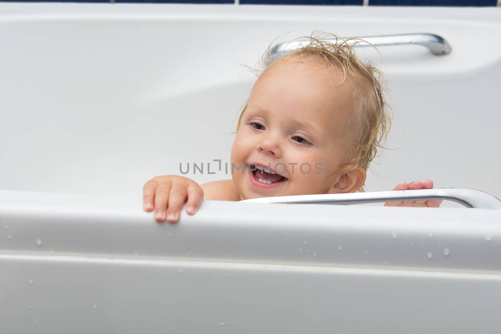 Baby girl smiles in the bathroom by kamsta