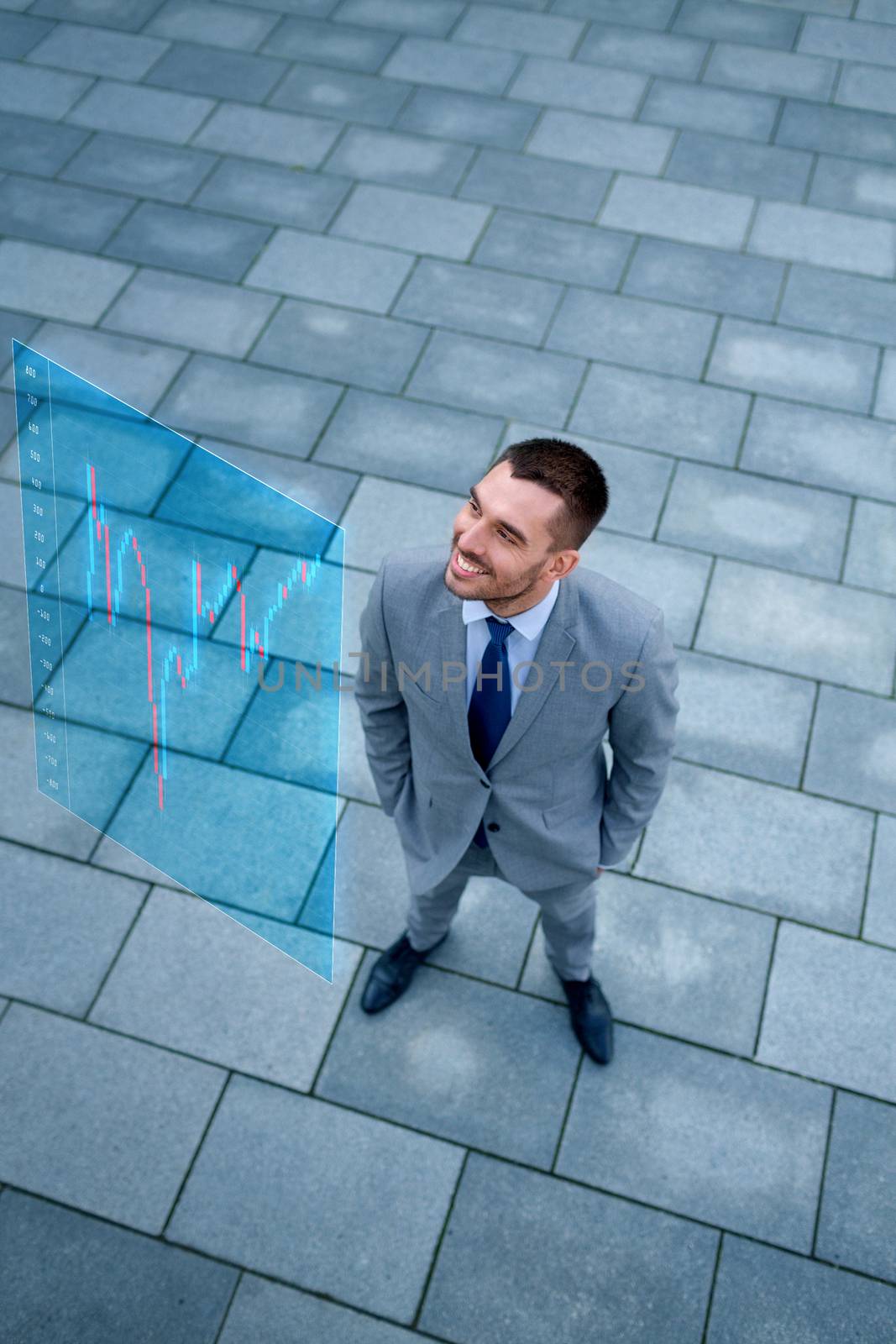 business, development, finances and people concept - young smiling businessman with forex chart on virtual screen outdoors from top