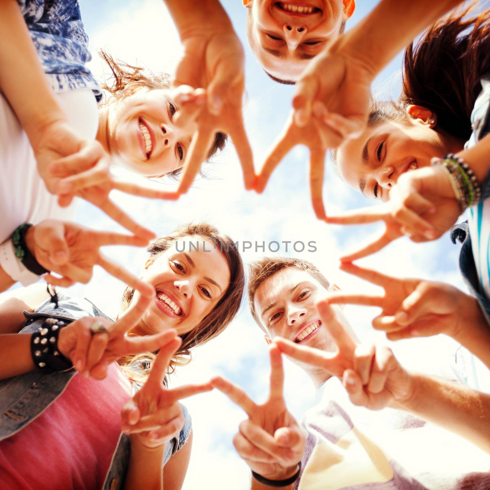 group of teenagers showing finger five by dolgachov