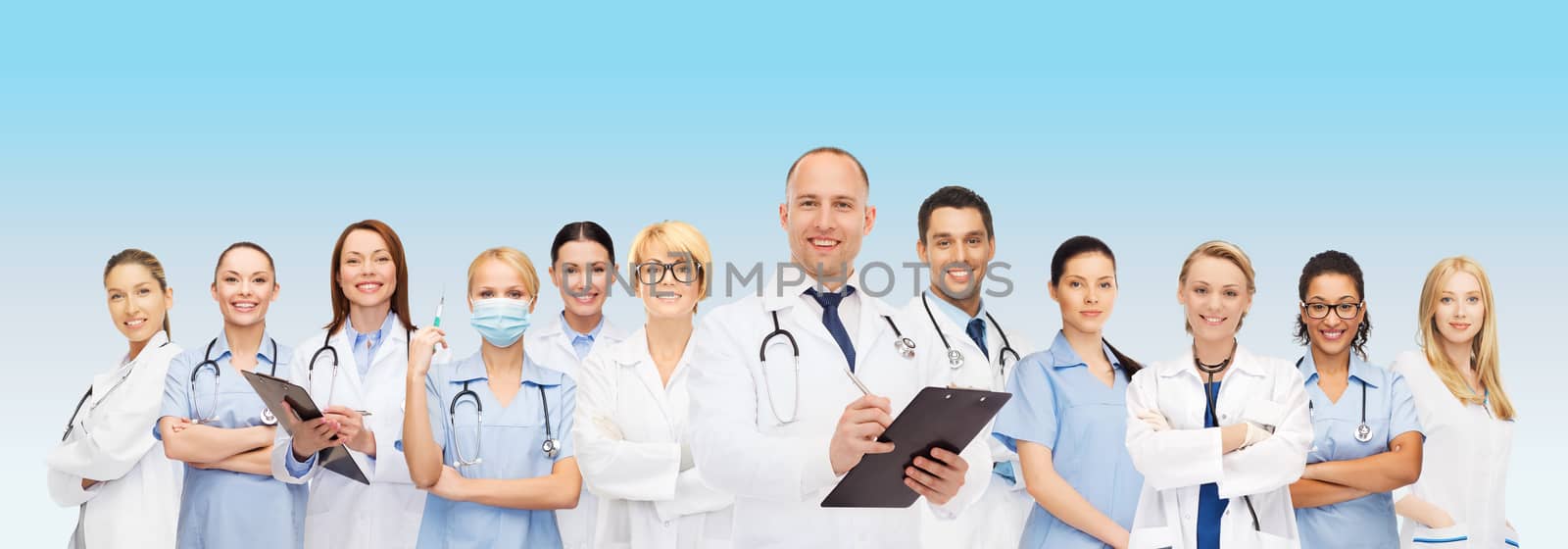 group of smiling doctors with clipboard by dolgachov