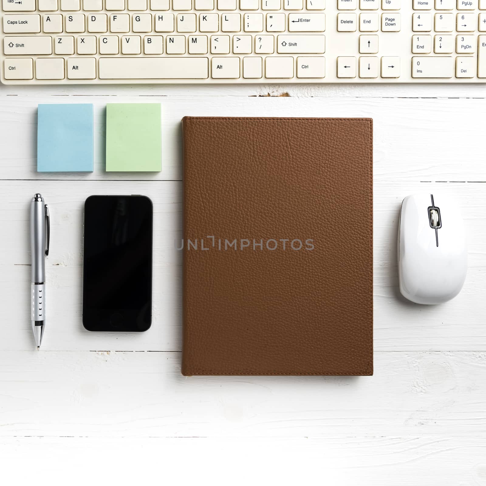computer and brown notebook with office supplies  by ammza12