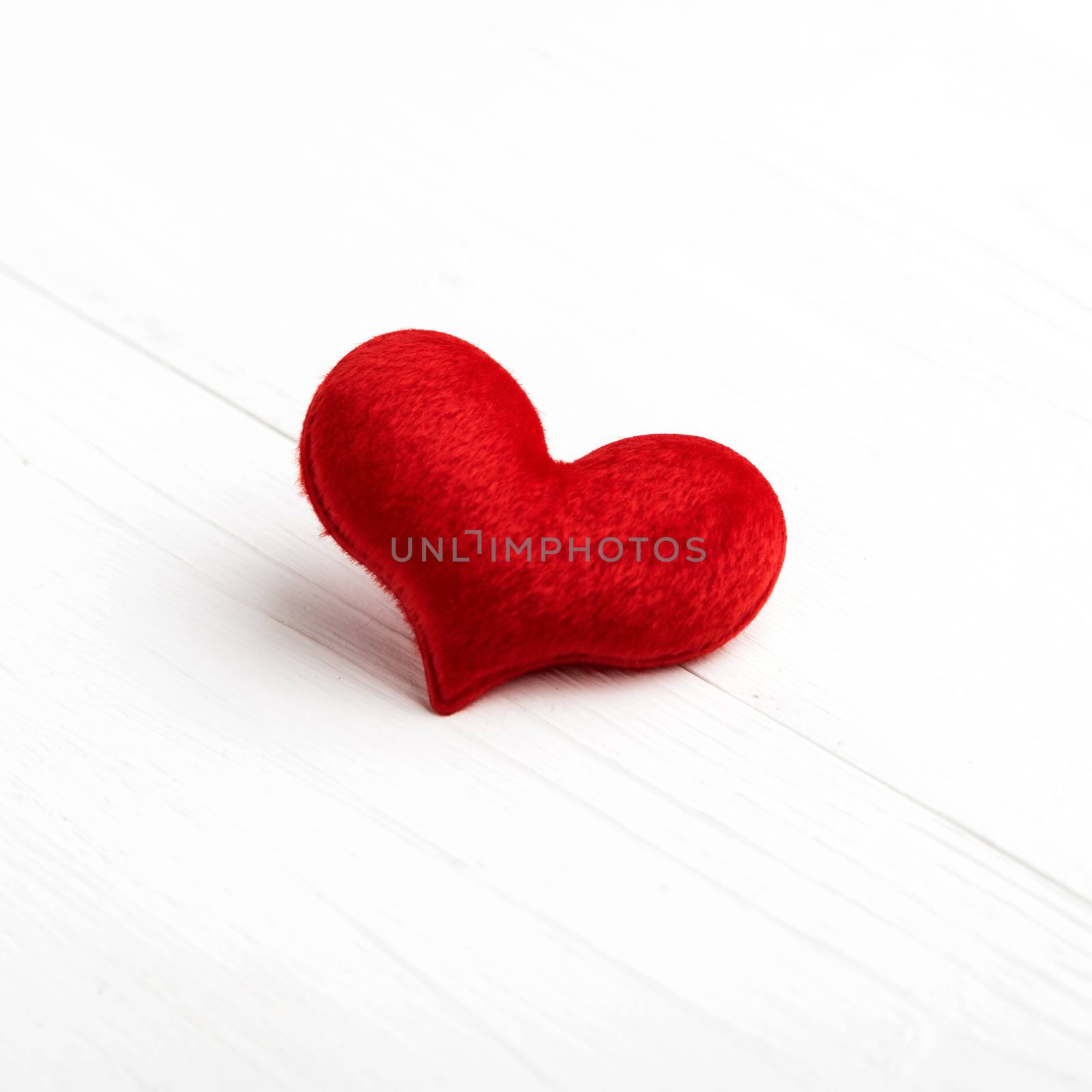 red heart on white table