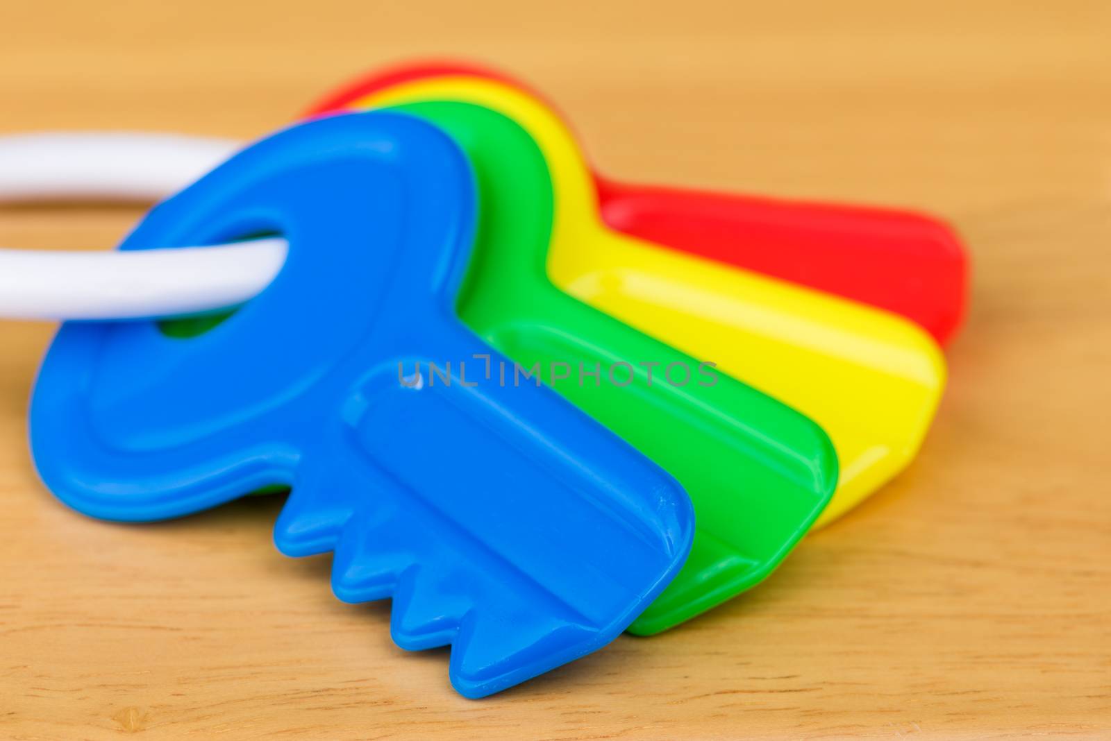 A close up shot of four colorful kid's toy keys.