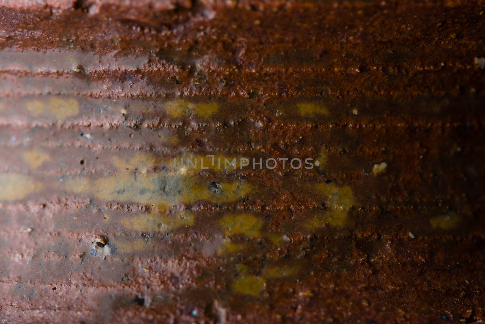 A macro shot of the texture on a brown ceramic vase.