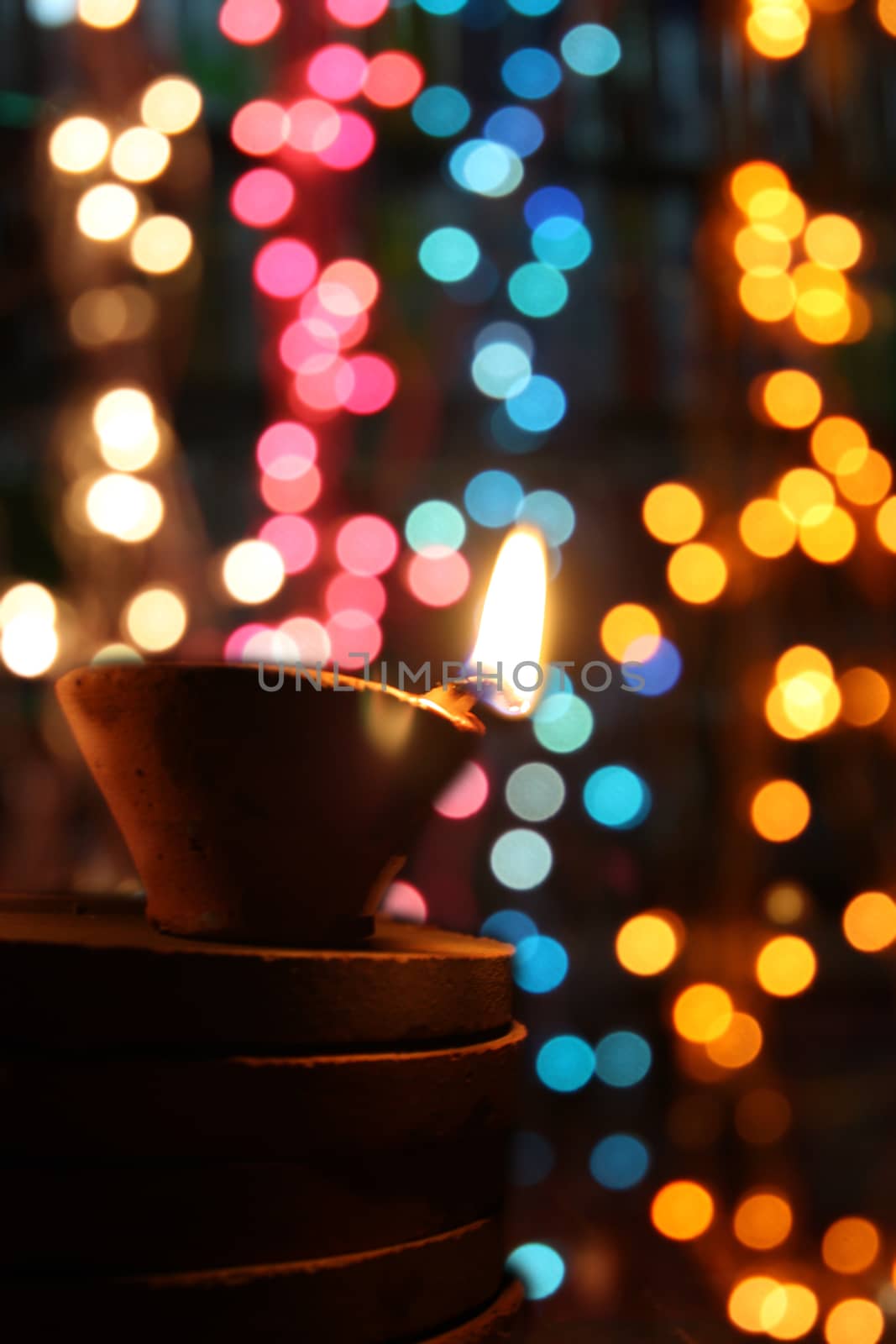 Traditional Diwali lamps in colorful blur festive lights during Diwali festival in India.