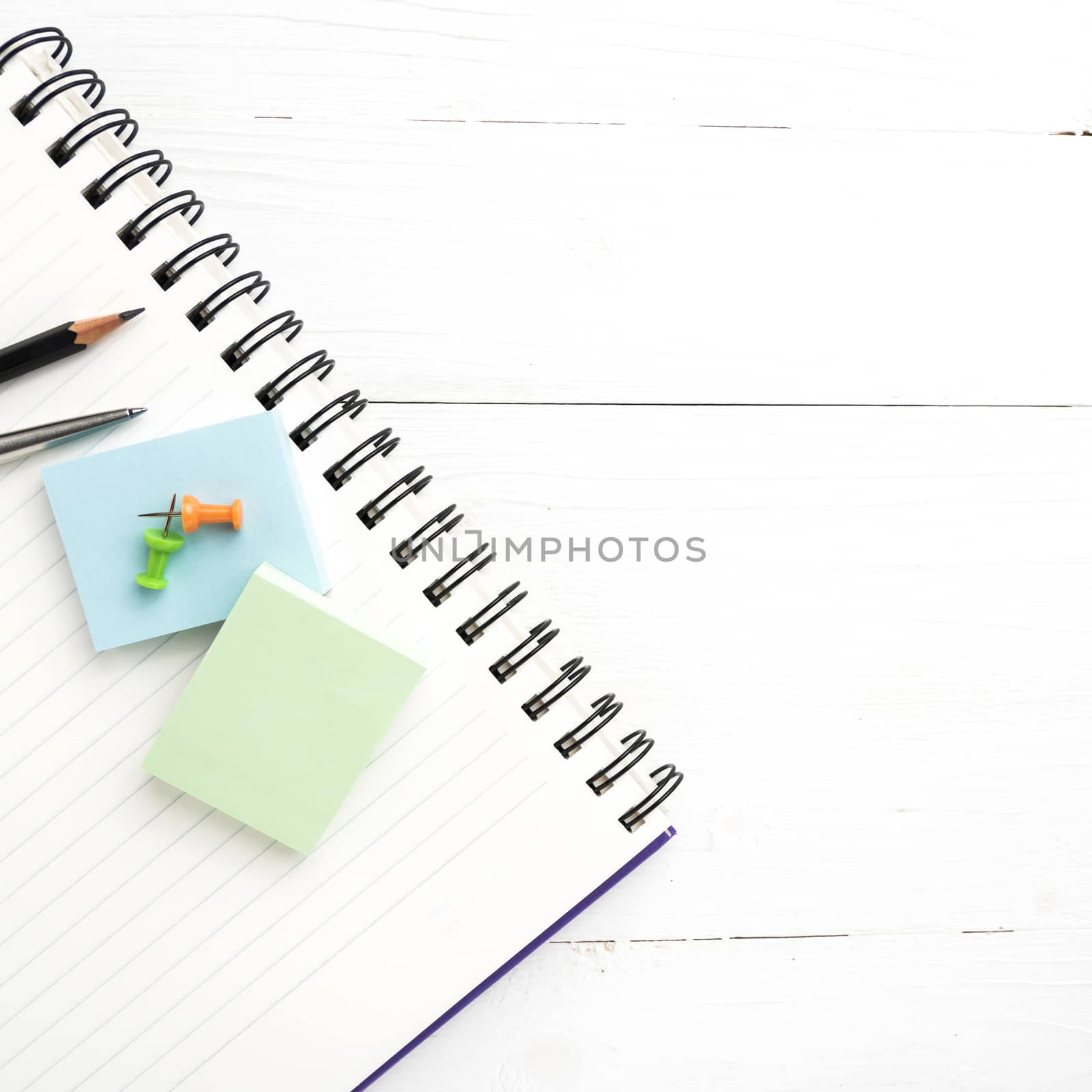 notepad with office supplies view from above by ammza12