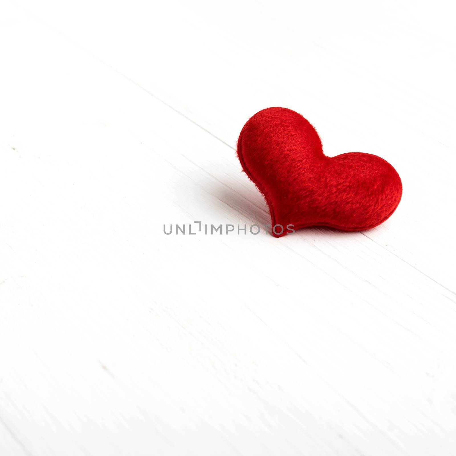 red heart on white table