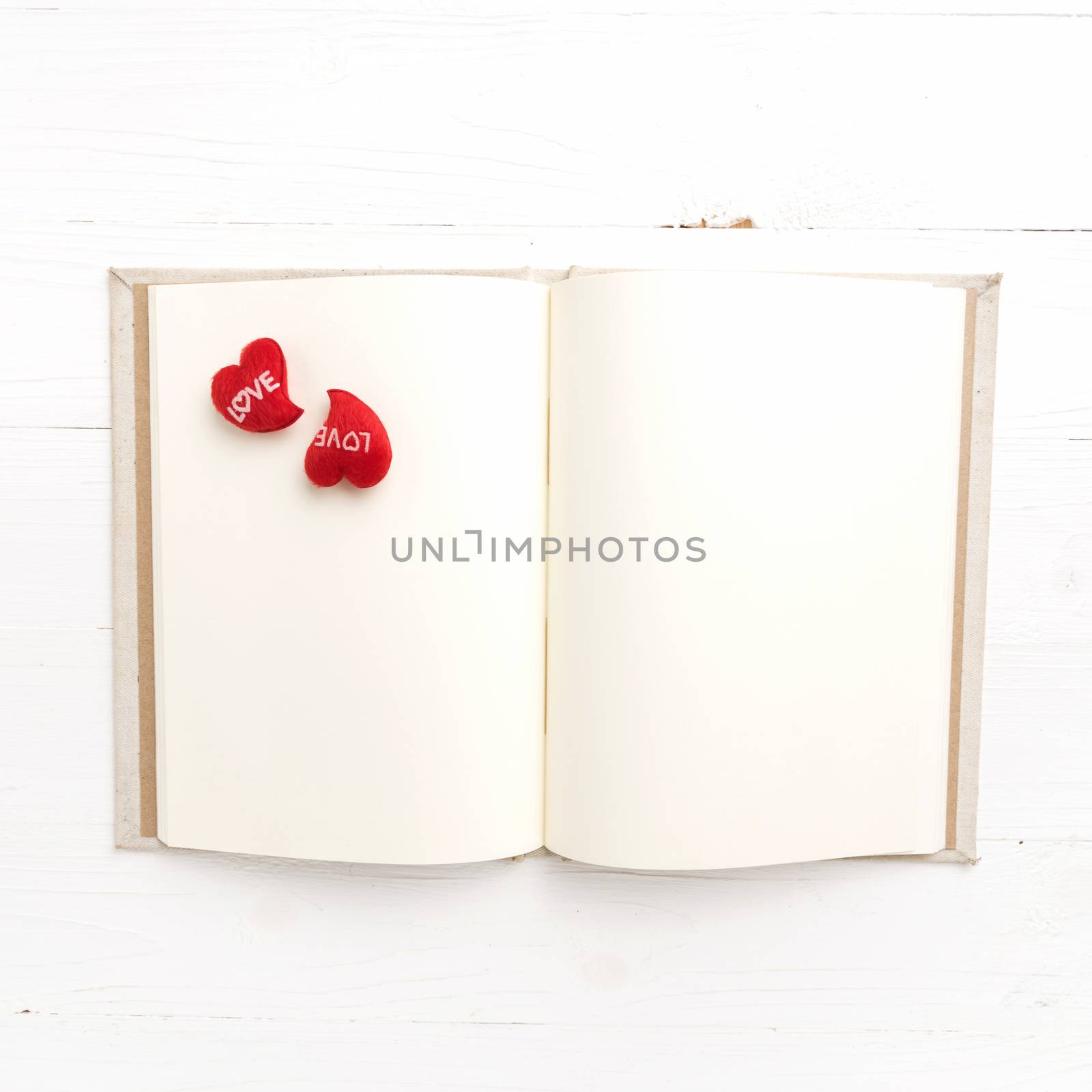 heart on notebook over white table