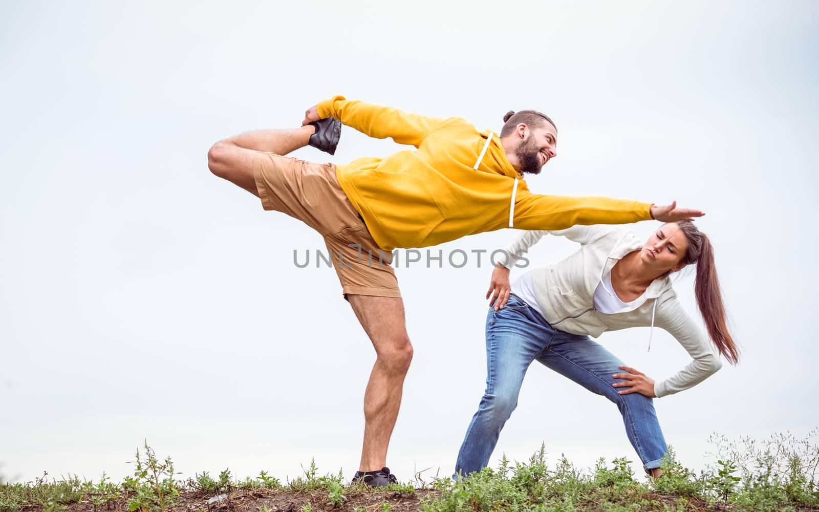 Couple stretching on a hike in the countryside