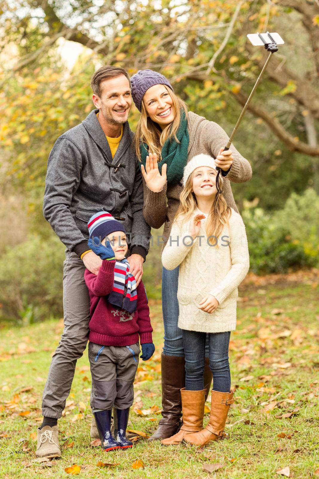 Smiling young family taking selfies by Wavebreakmedia