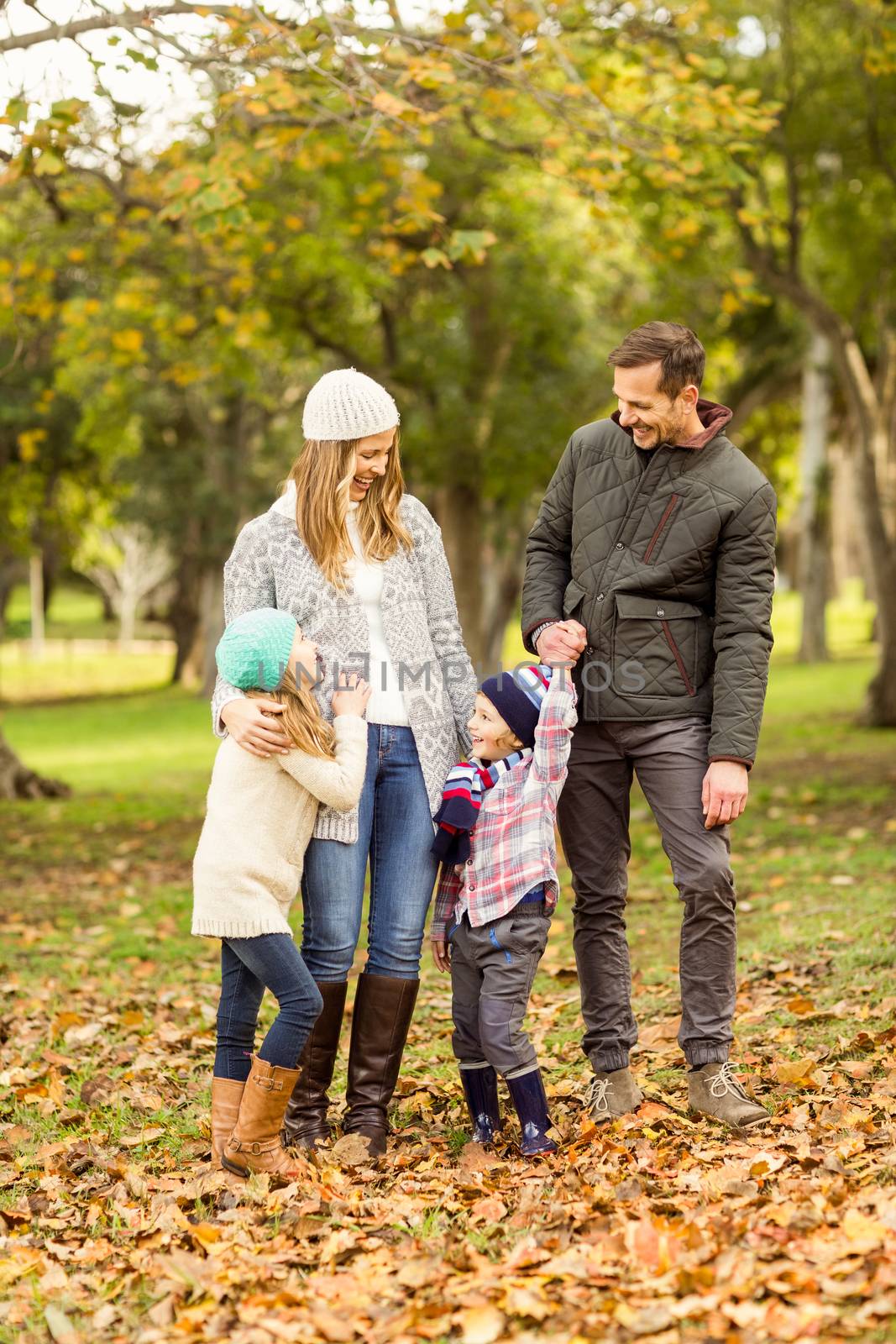 Portrait of a smiling young family on an autumns day