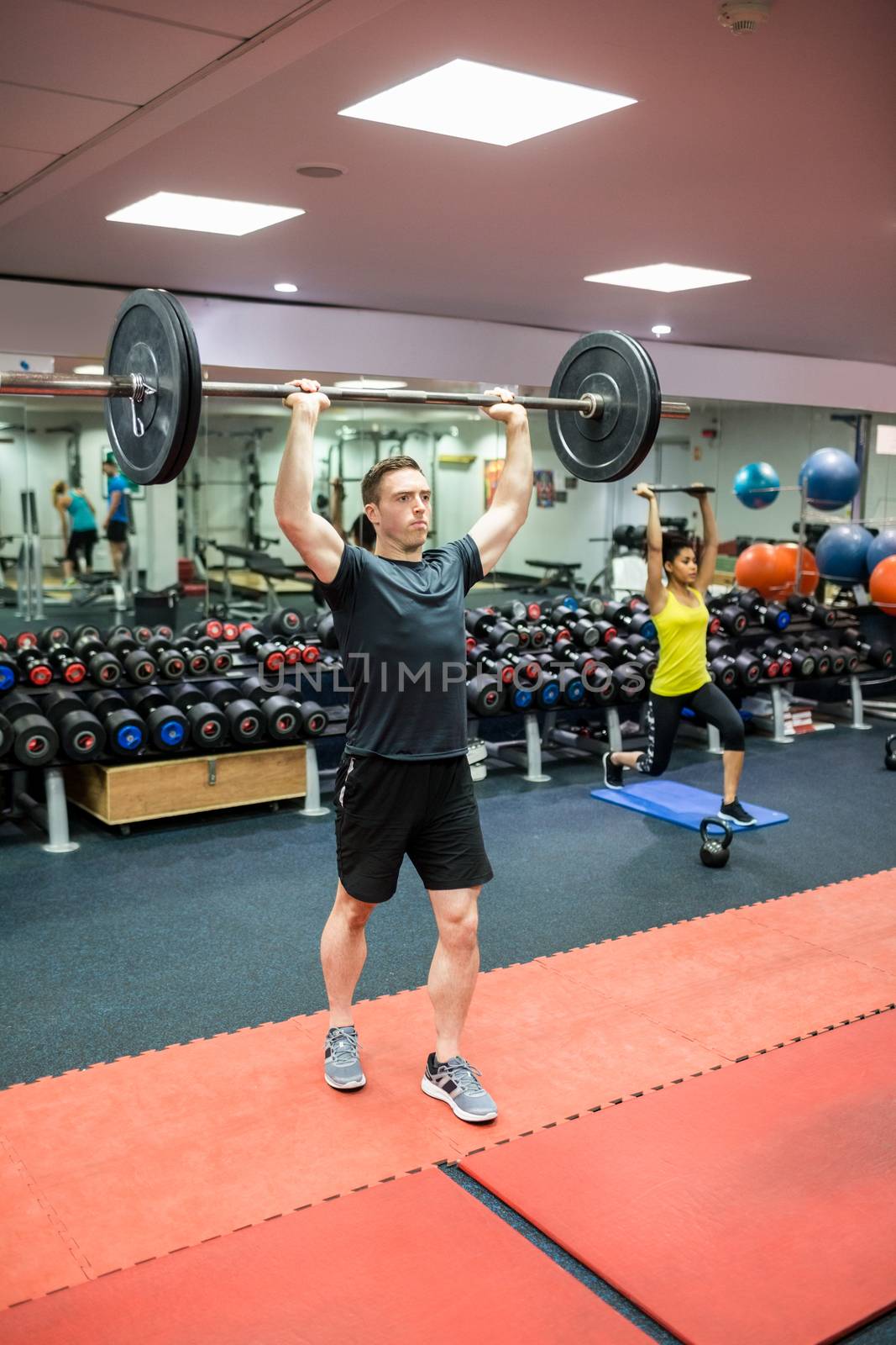 Fit man working out in weights room by Wavebreakmedia