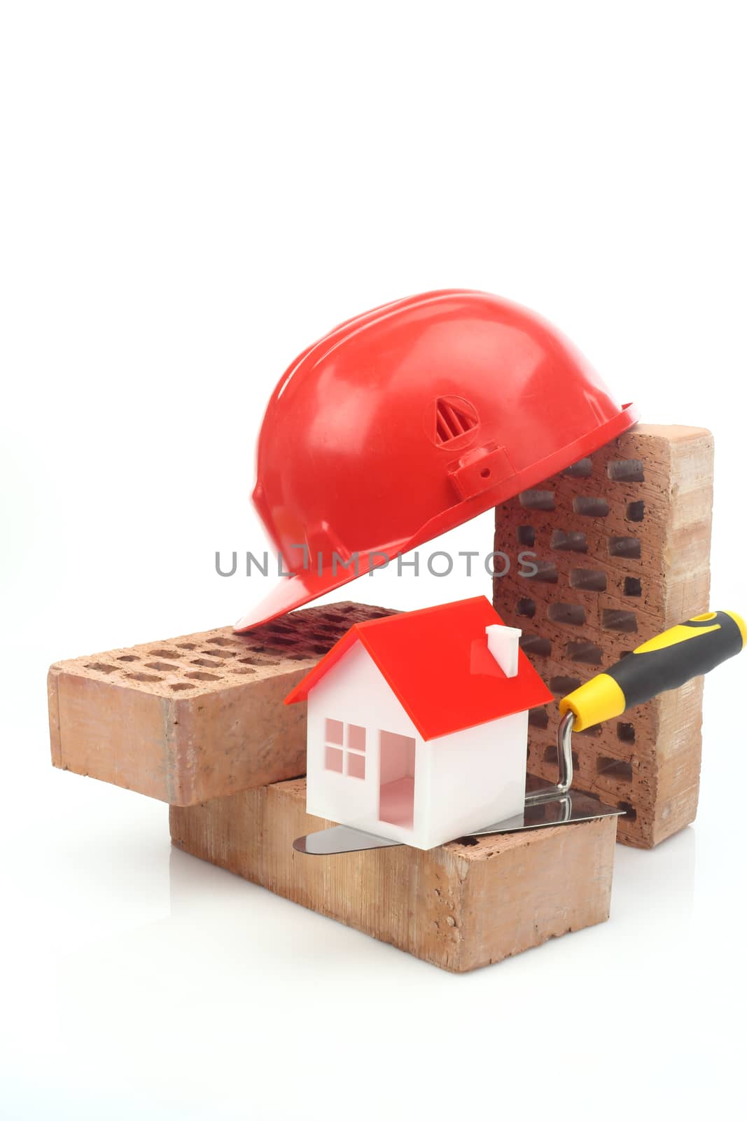 Bricks, trowel and helmet over white 