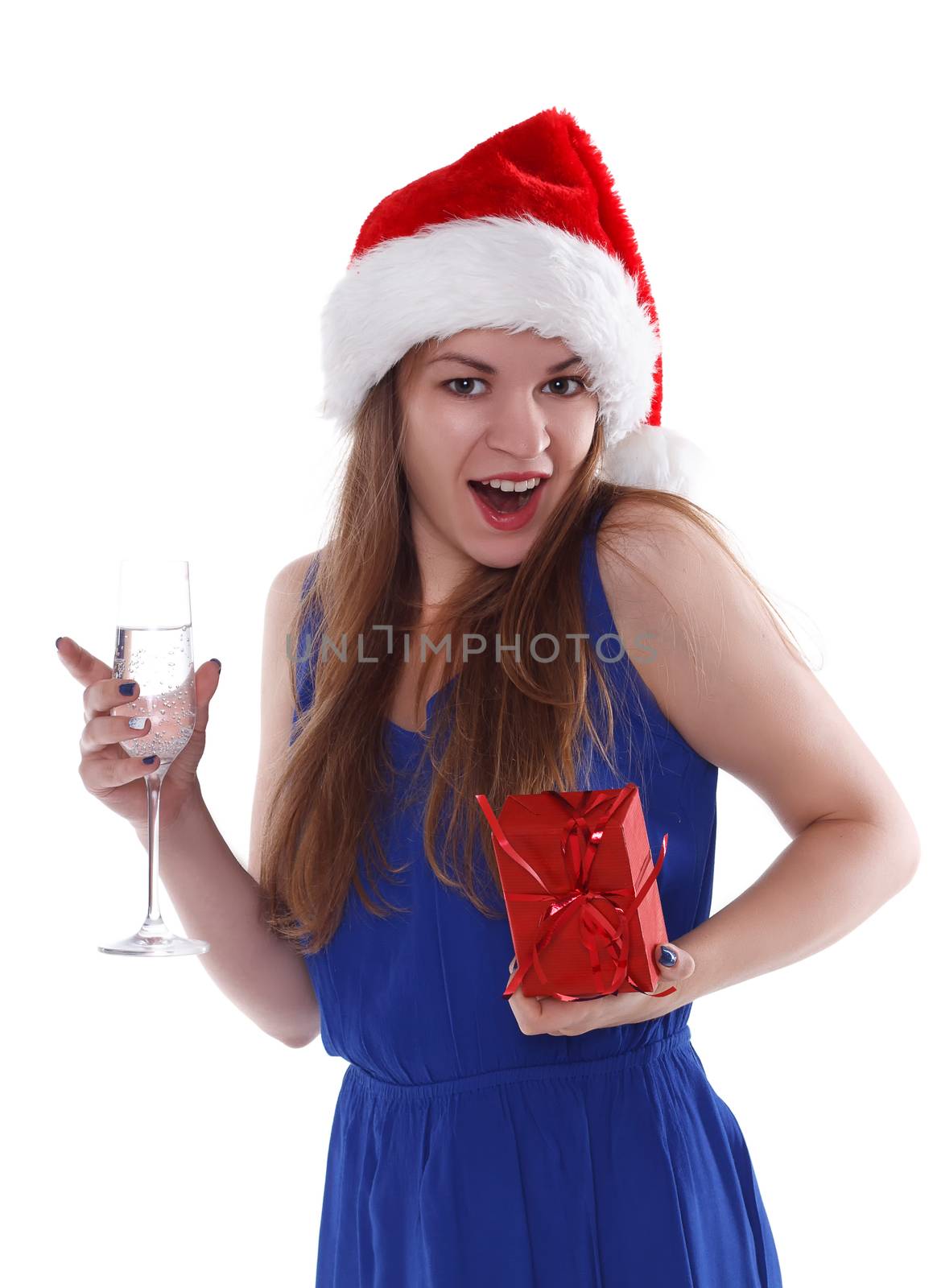 girl in a red Christmas hat with a gift and a glass of champagne on a white background. Isolate.
