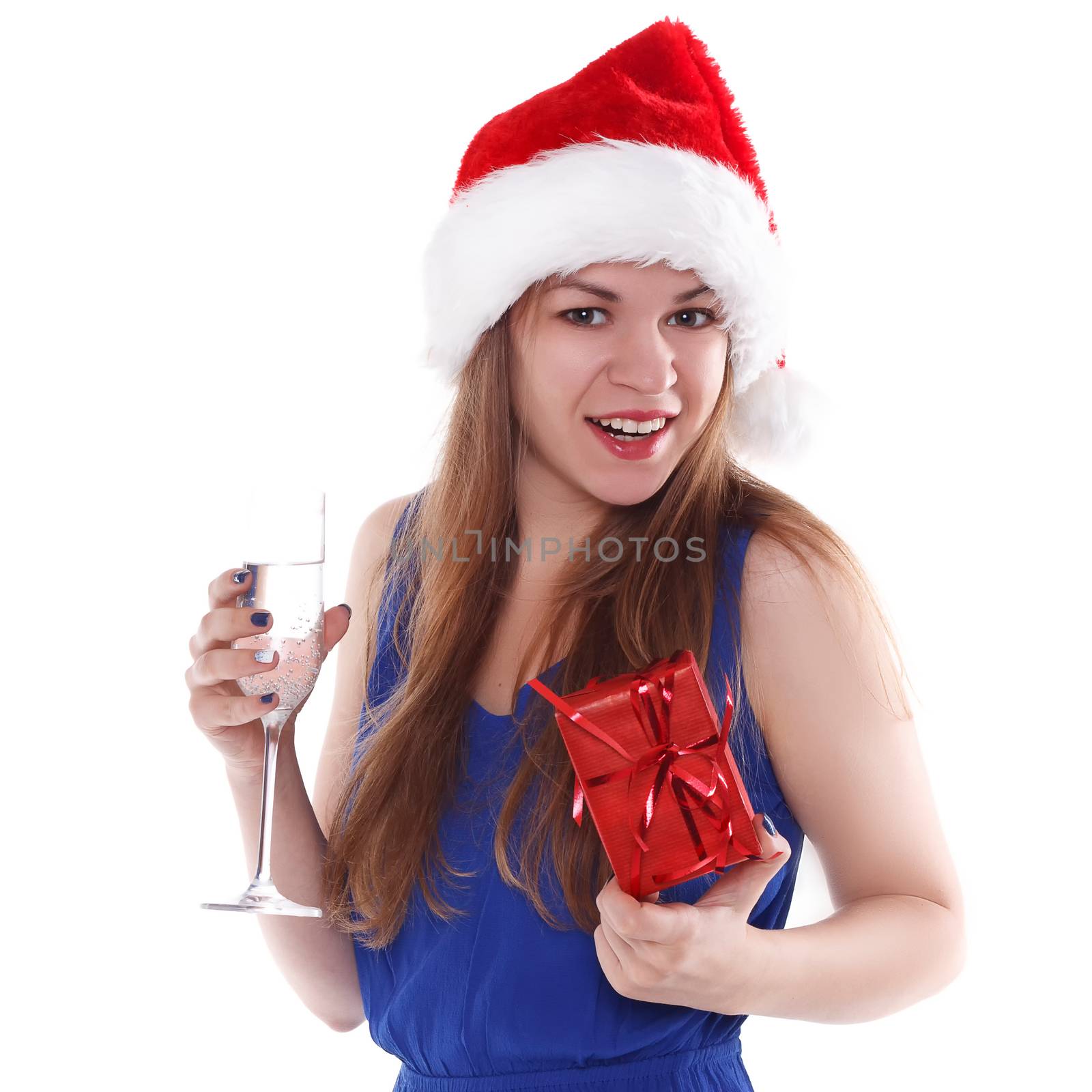 girl in a red Christmas hat with a gift and a glass of champagne on a white background. Isolate.