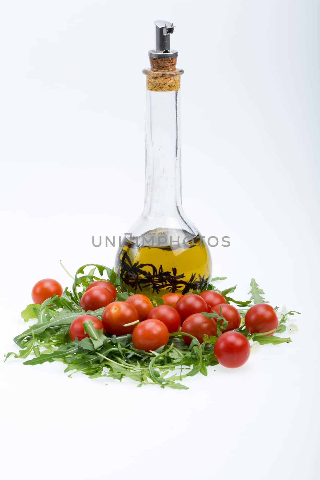 Heap of ruccola, tomatoes and olive oil with the thyme by wjarek