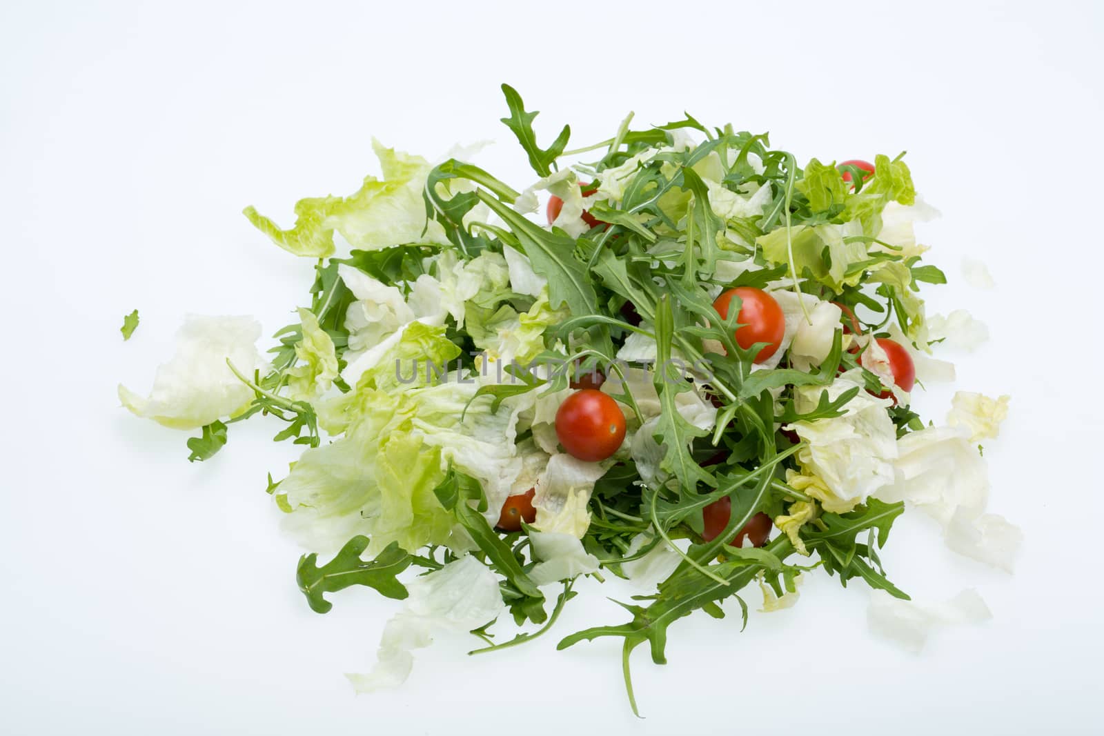 Heap of ruccola, lettuce leaves and cherry tomatoes by wjarek
