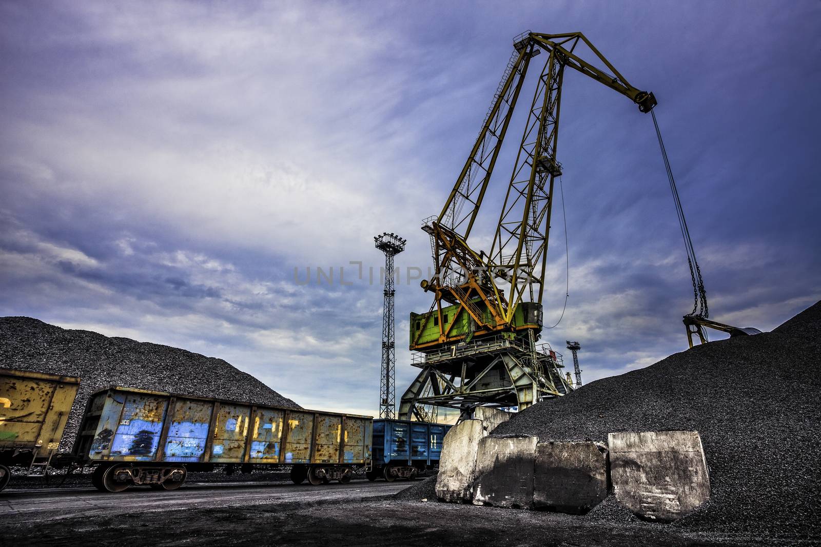 Working Port Crane in Coal Port and Cargo Train under it