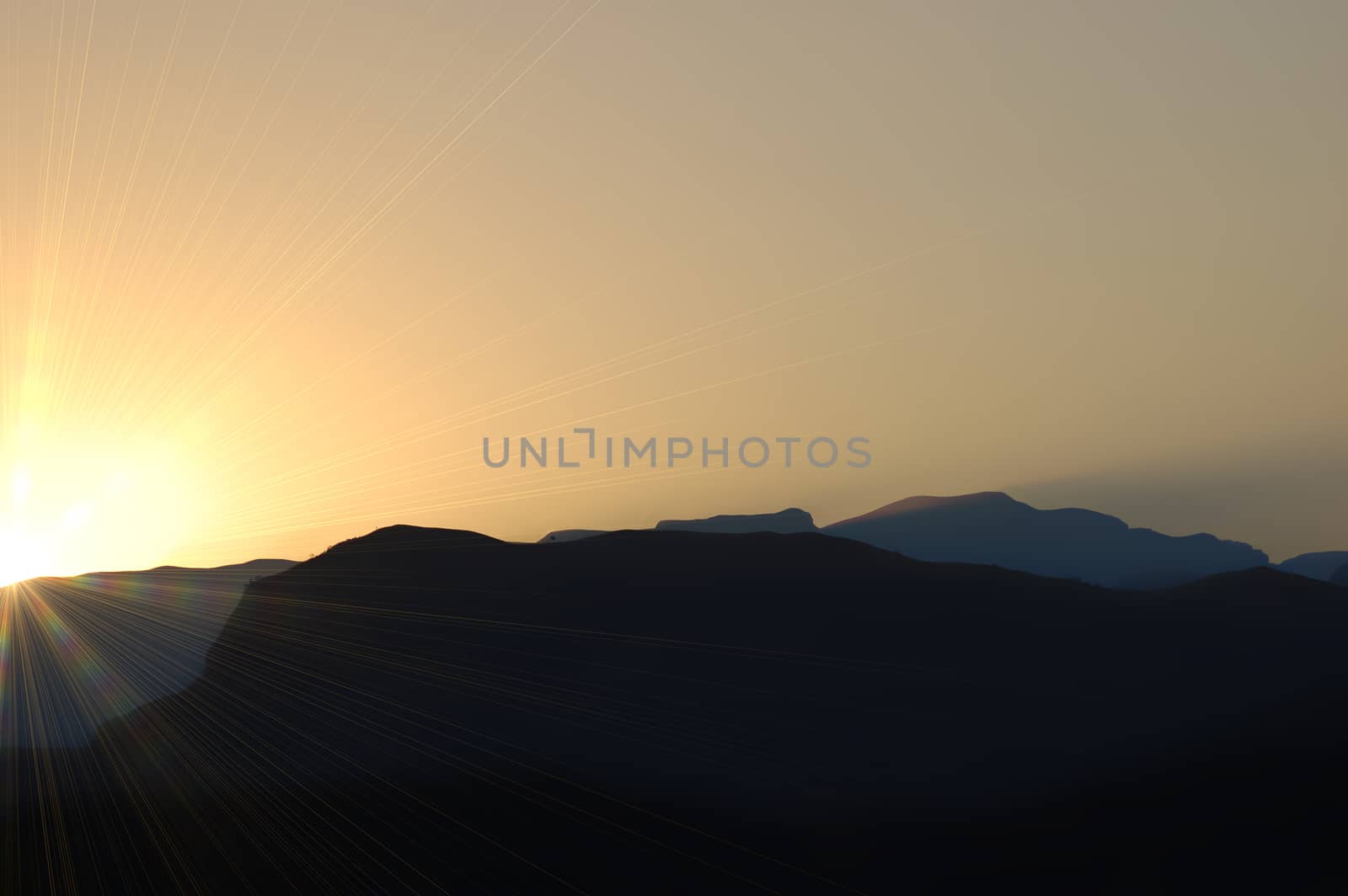 mountain range silhouette in sunset by stockbp