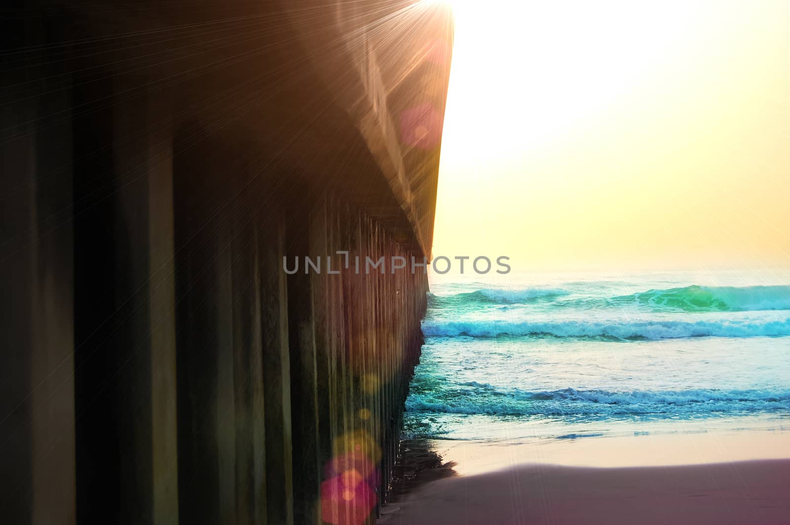 a pier of Durban South Africa leading into the ocean with sunnny backdrop