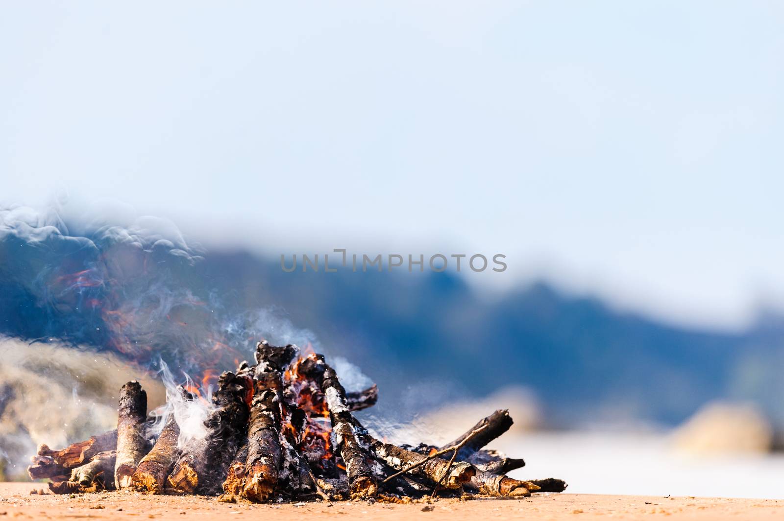 Burning firewood on the seashore