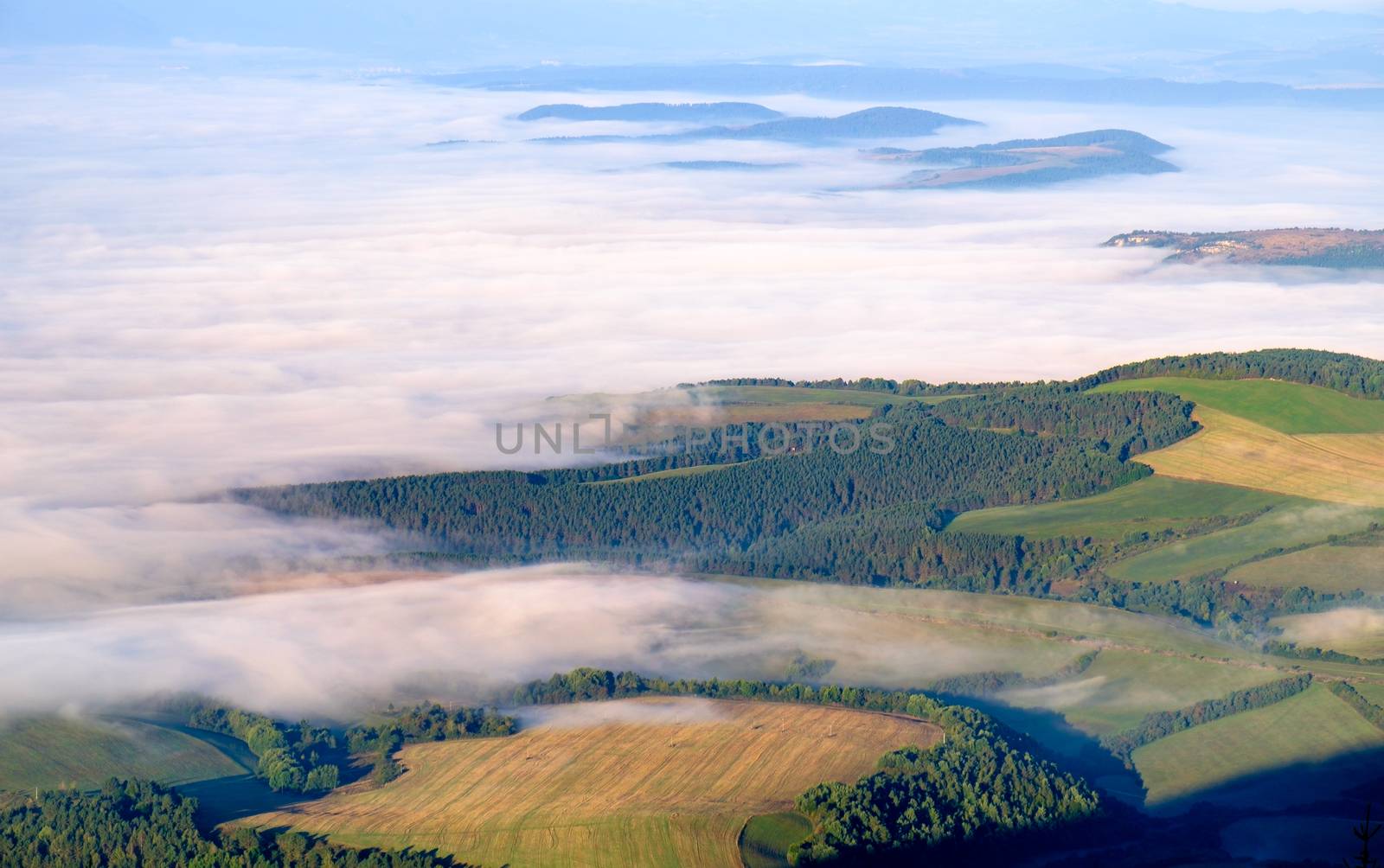 Beautiful landscape view of hills and meadows, mist and clouds by martinm303