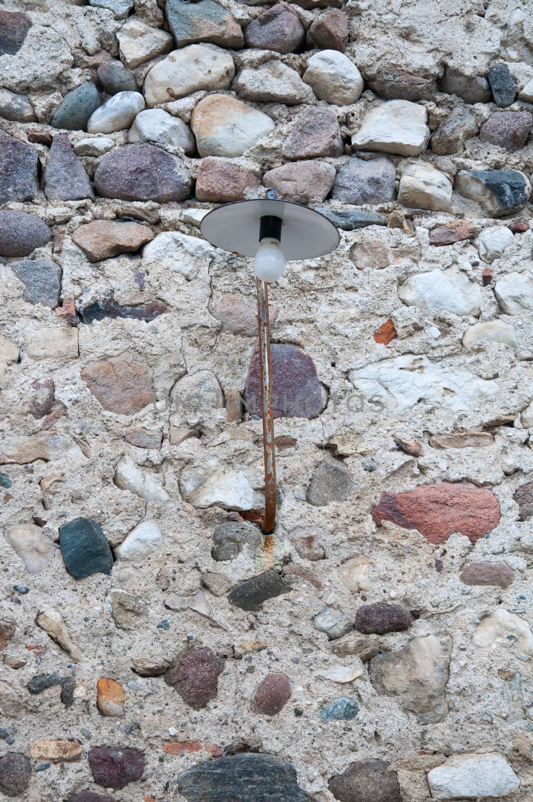 Old street lamp attached to a brick wall