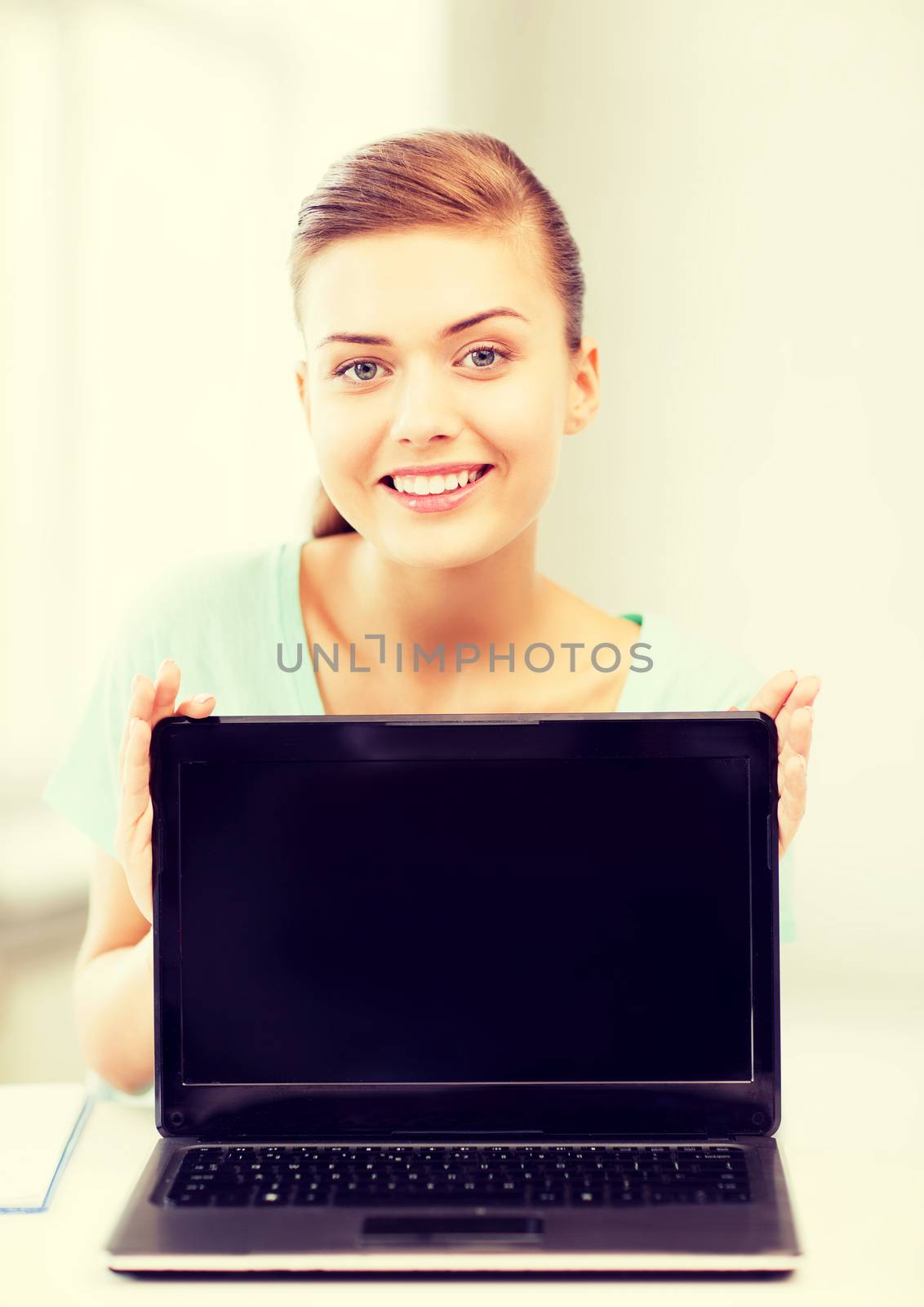 smiling student girl with laptop by dolgachov
