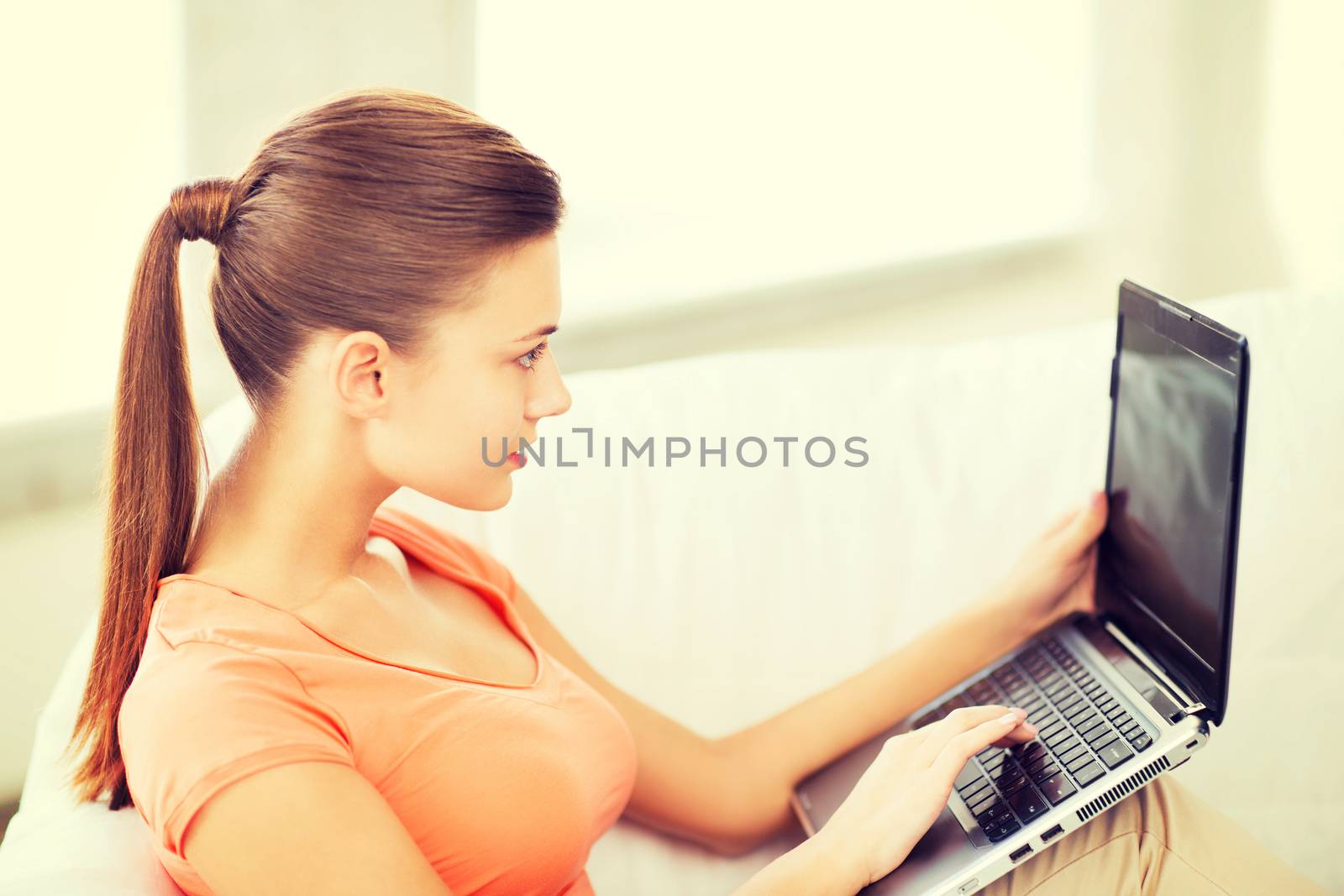 woman using laptop at home by dolgachov