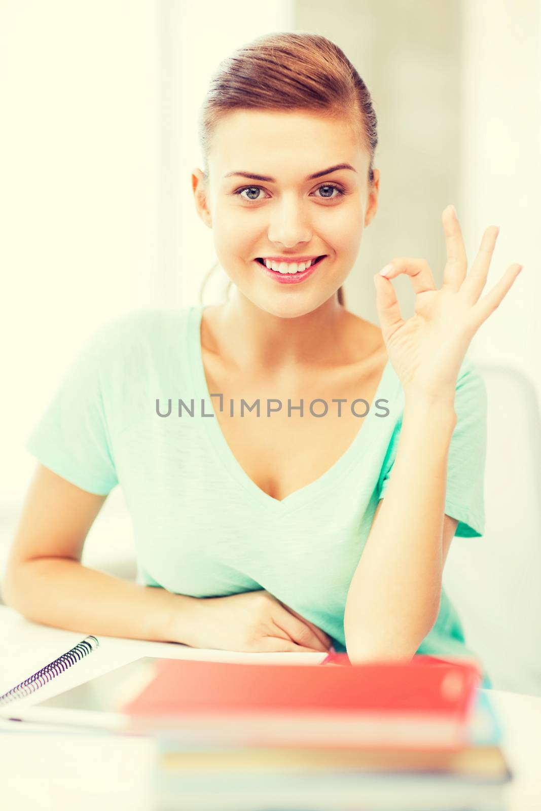 smiling student girl with tablet pc by dolgachov