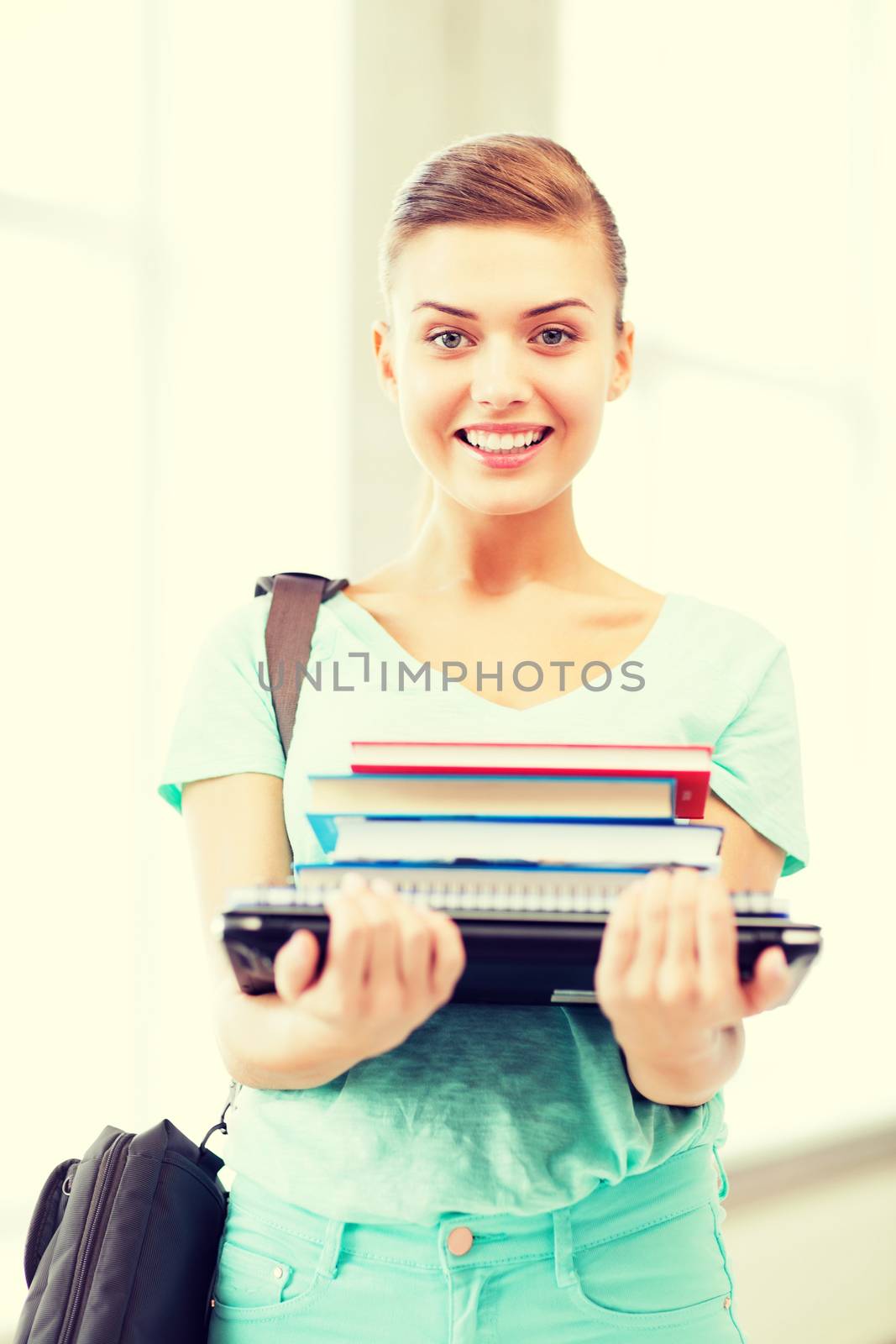 student with folders and school bag in college by dolgachov