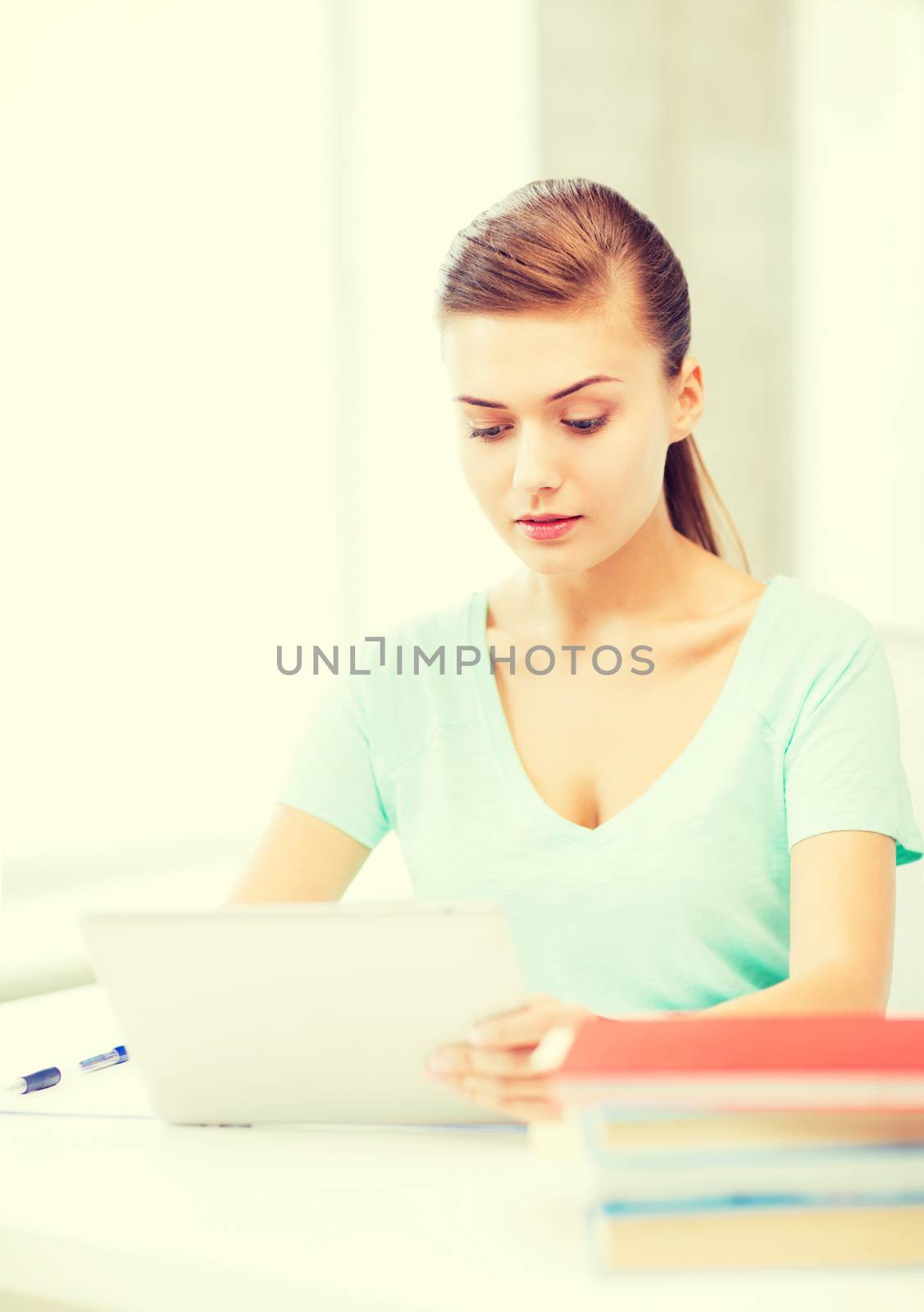 smiling student girl with tablet pc by dolgachov