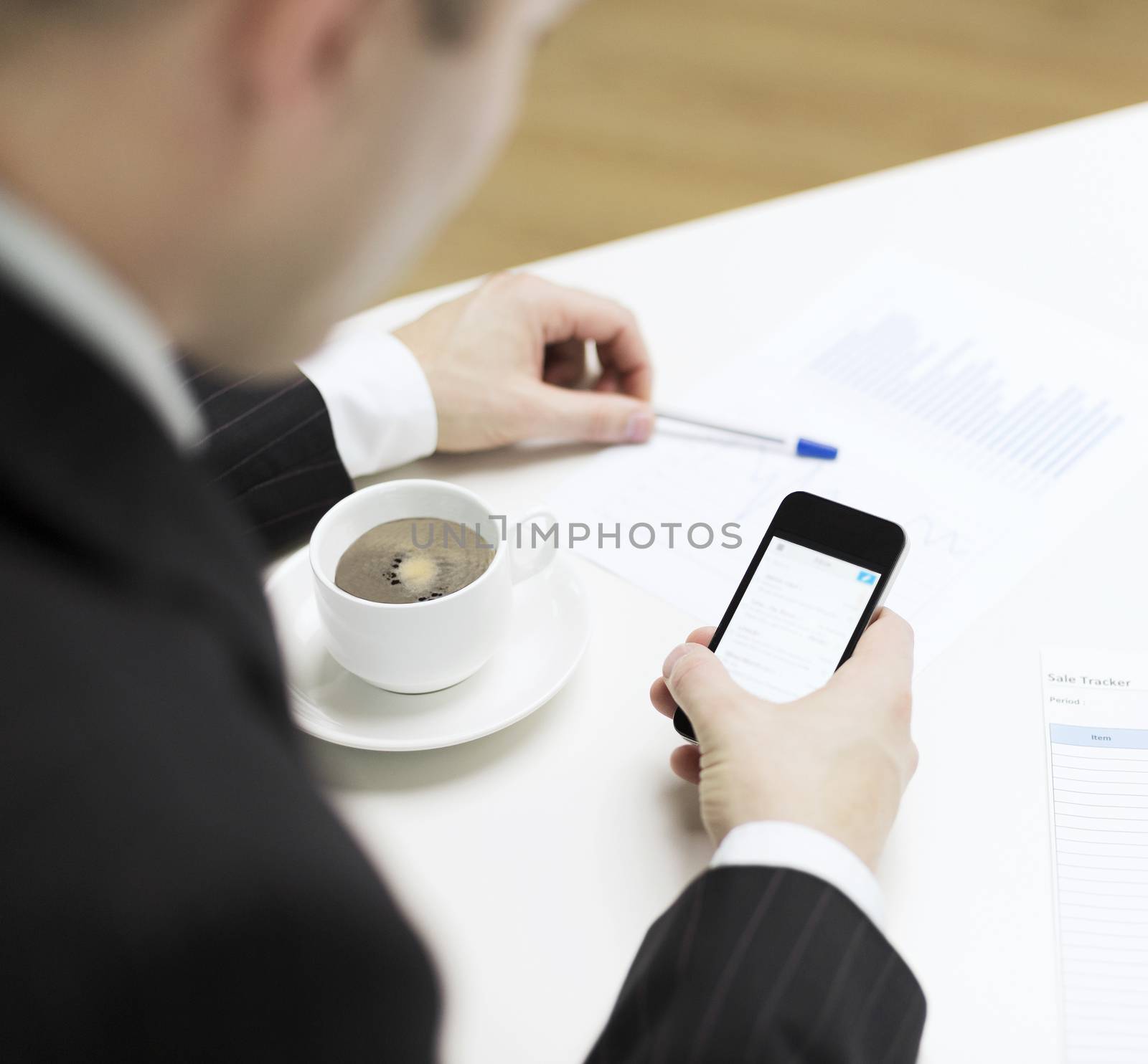 business, technology and interent concept - businessman with smartphone reading news