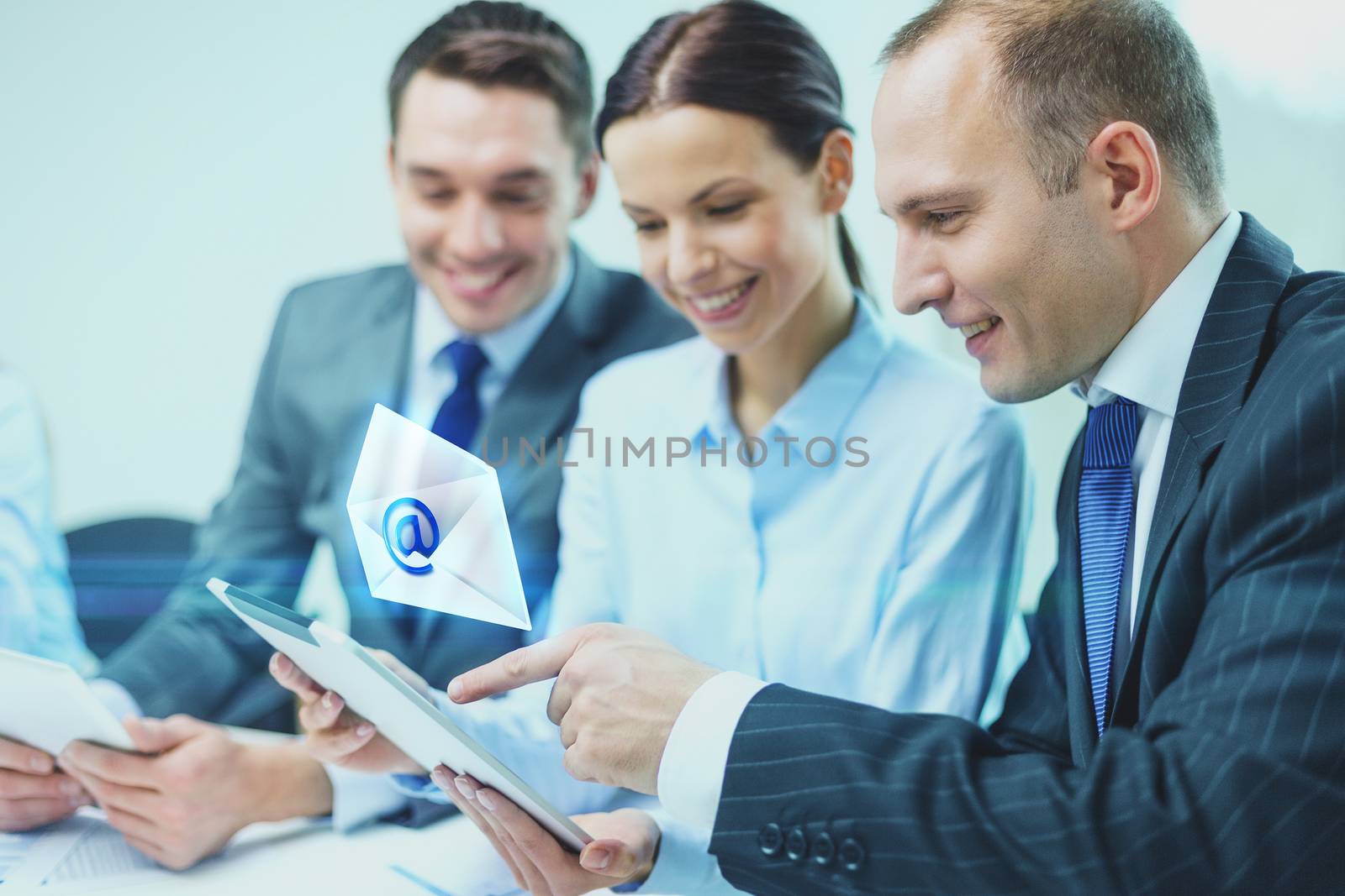 business, technology, communication and people concept - smiling business team with tablet pc computer and virtual message icon projection having discussion in office