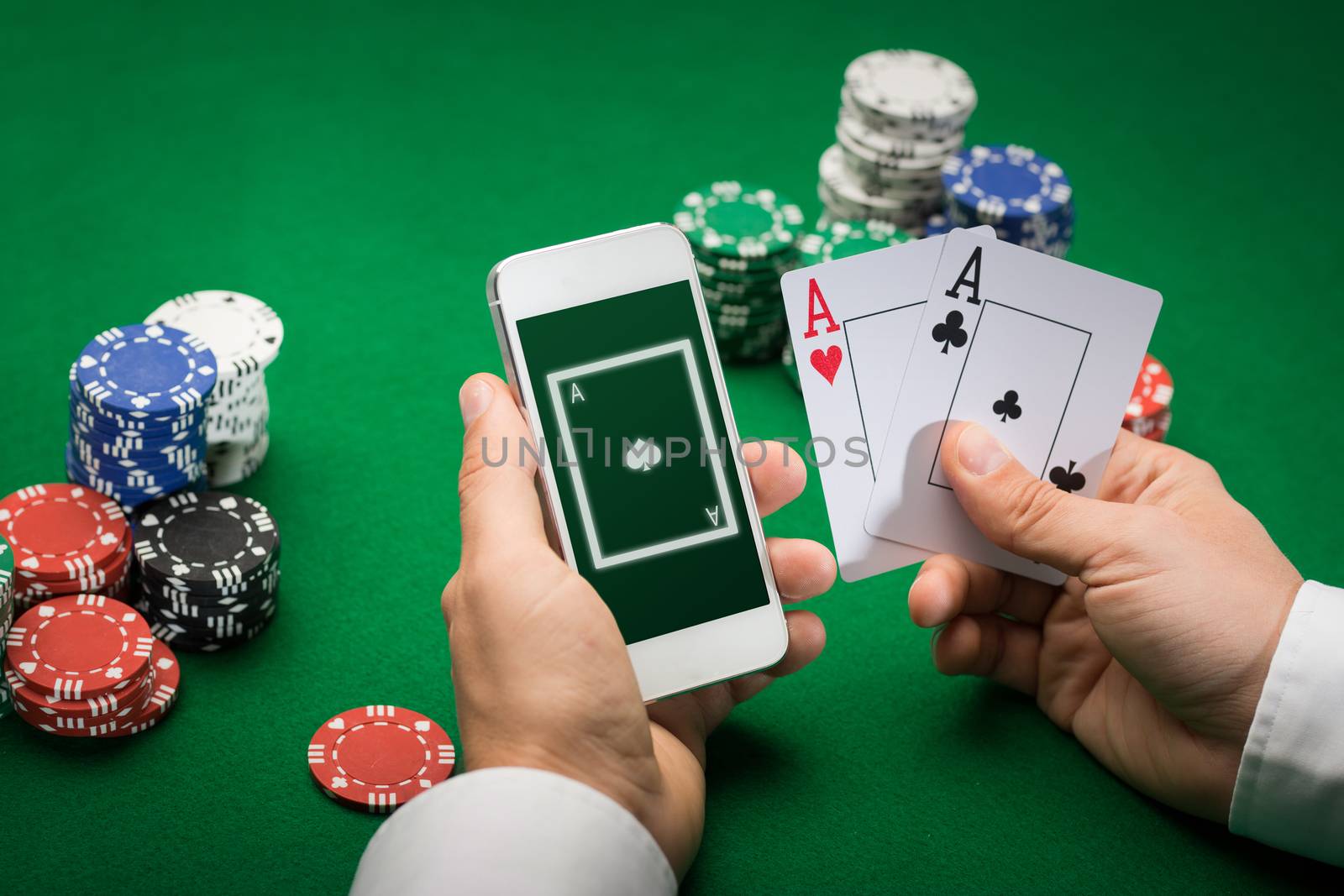 casino player with cards, smartphone and chips by dolgachov