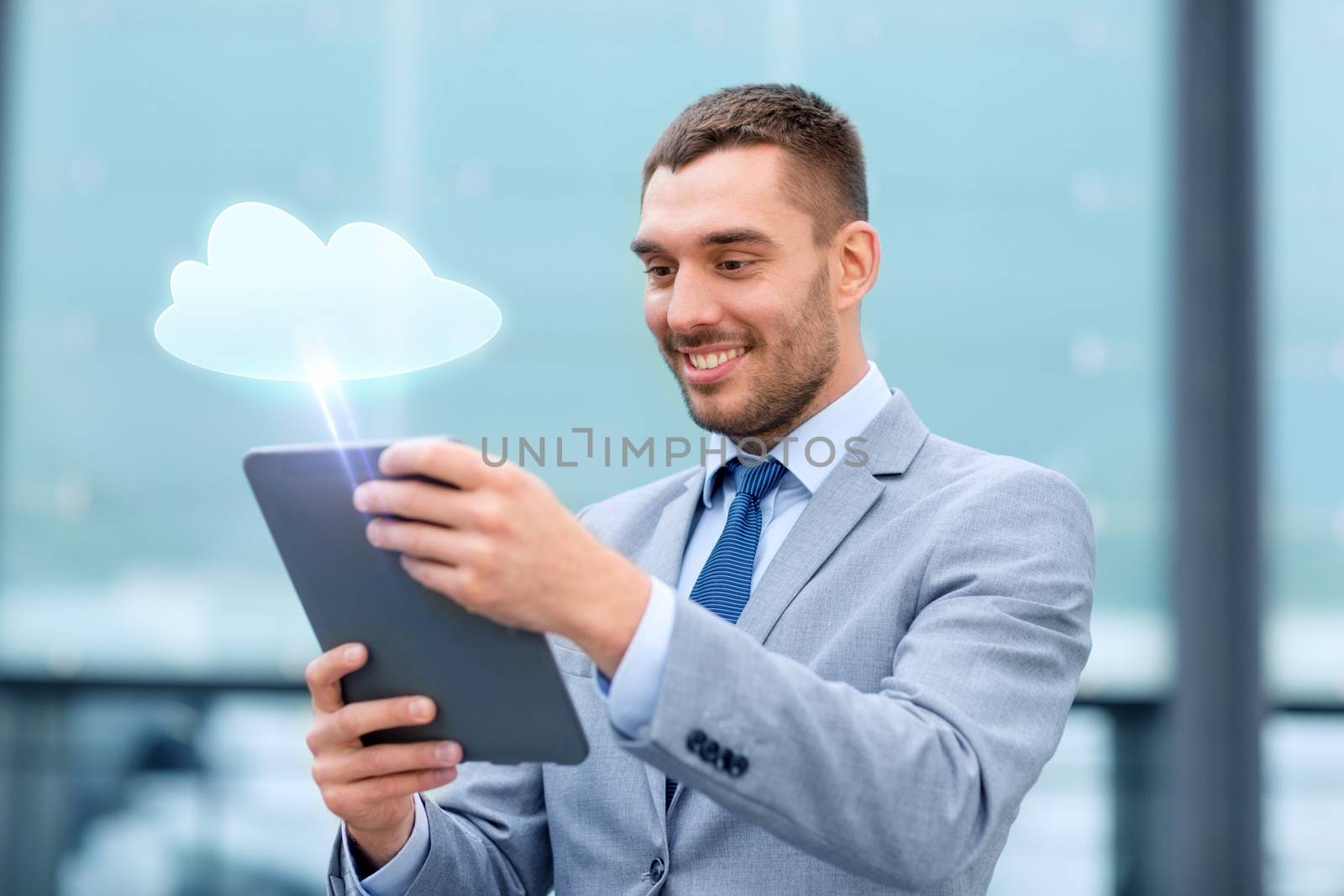 smiling businessman with tablet pc outdoors by dolgachov