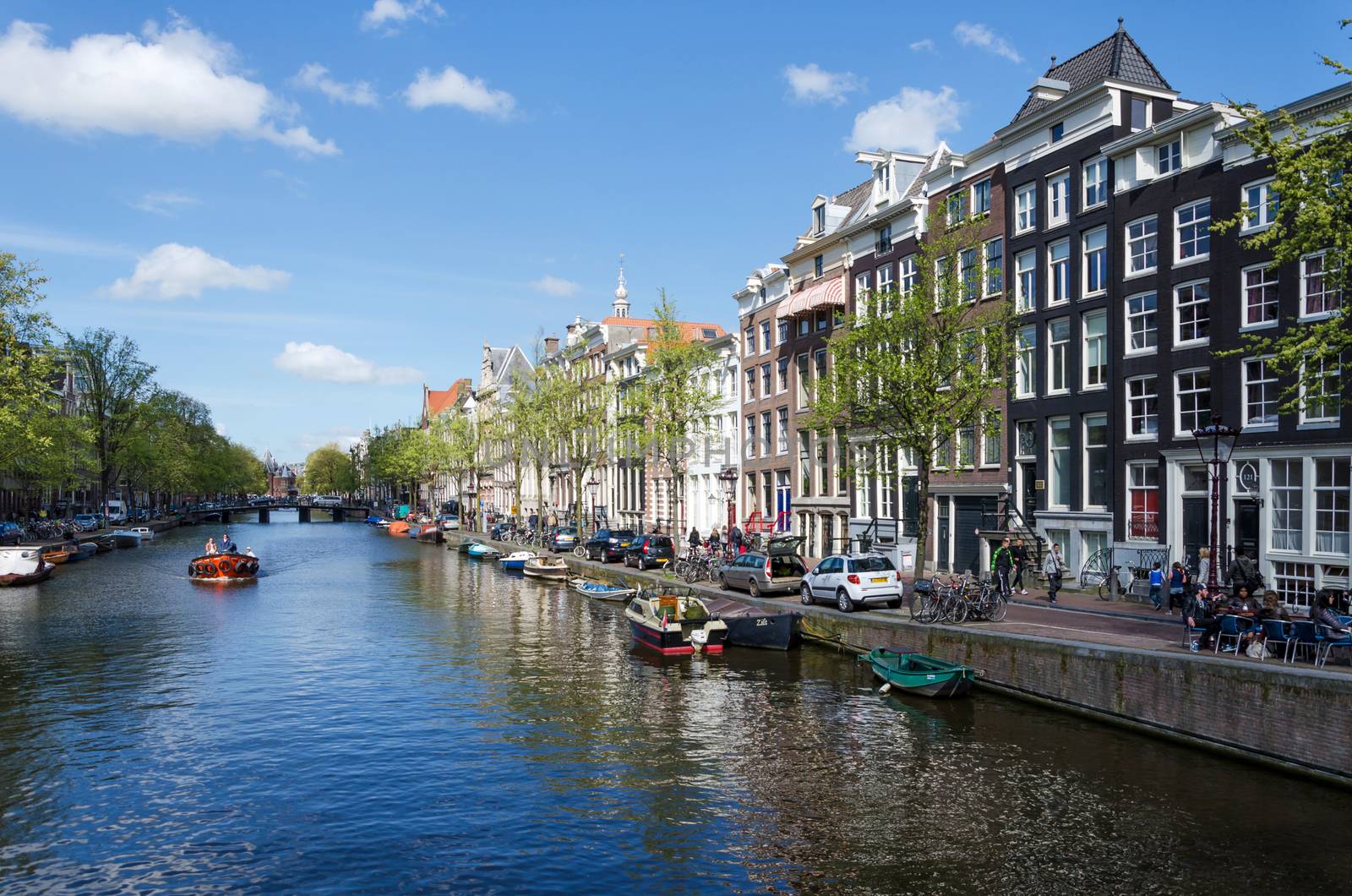 Amsterdam, Netherlands - May 7, 2015: Passenger boats on canal tour in the city of Amsterdam by siraanamwong