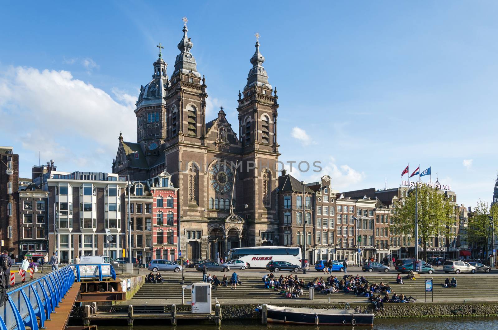 Amsterdam, Netherlands - May 8, 2015: Tourists at Church of Saint Nicholas(Basilica of Saint Nicholas) on May 8, 2015 in Amsterdam, Netherlands.The basilica has a collection of religious murals. Above the high altar is the crown of Maximilian I, which is a symbol seen throughout Amsterdam.