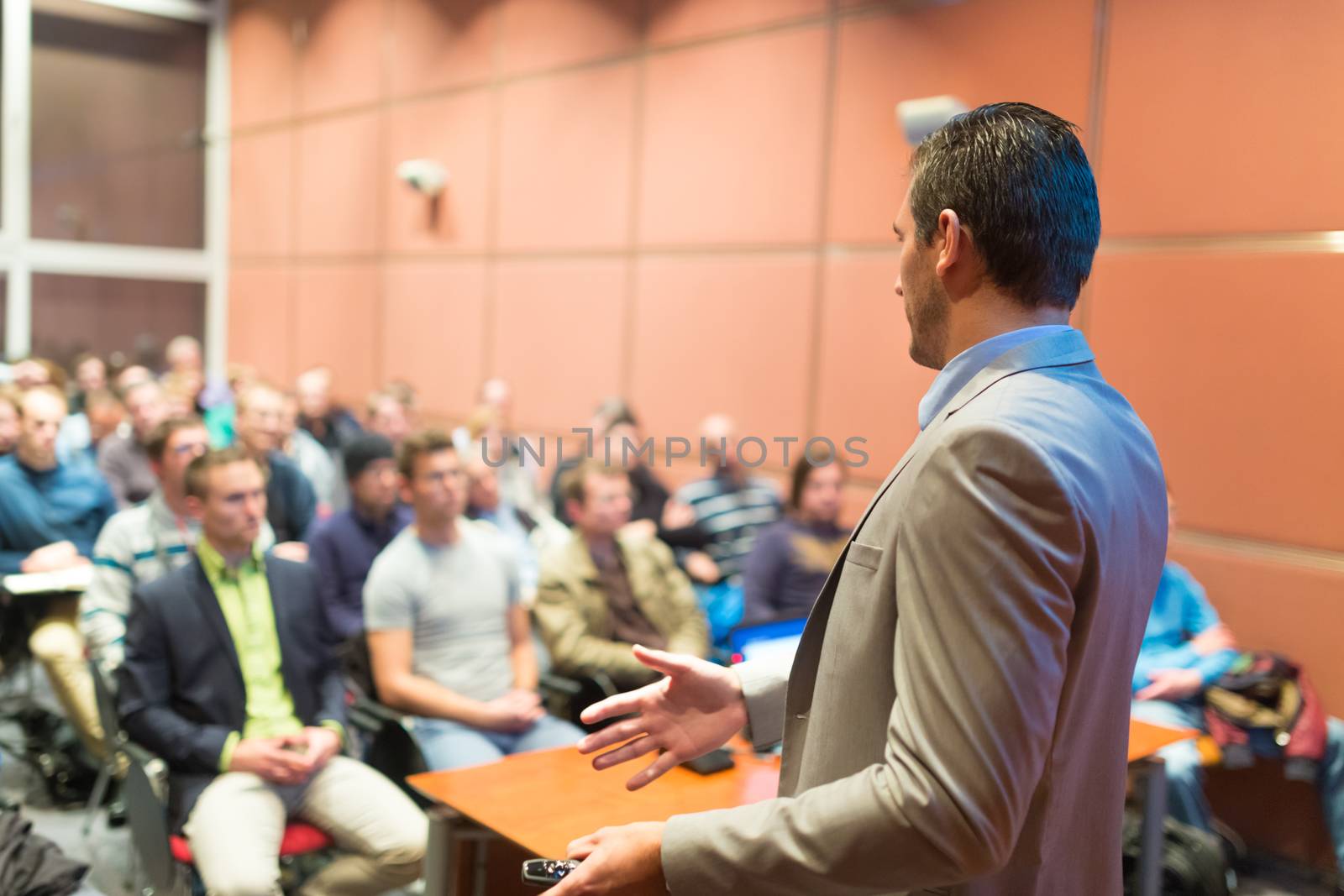 Speaker at Business Conference with Public Presentations. Audience at the conference hall. Business and Entrepreneurship concept. Background blur. Shallow depth of field.