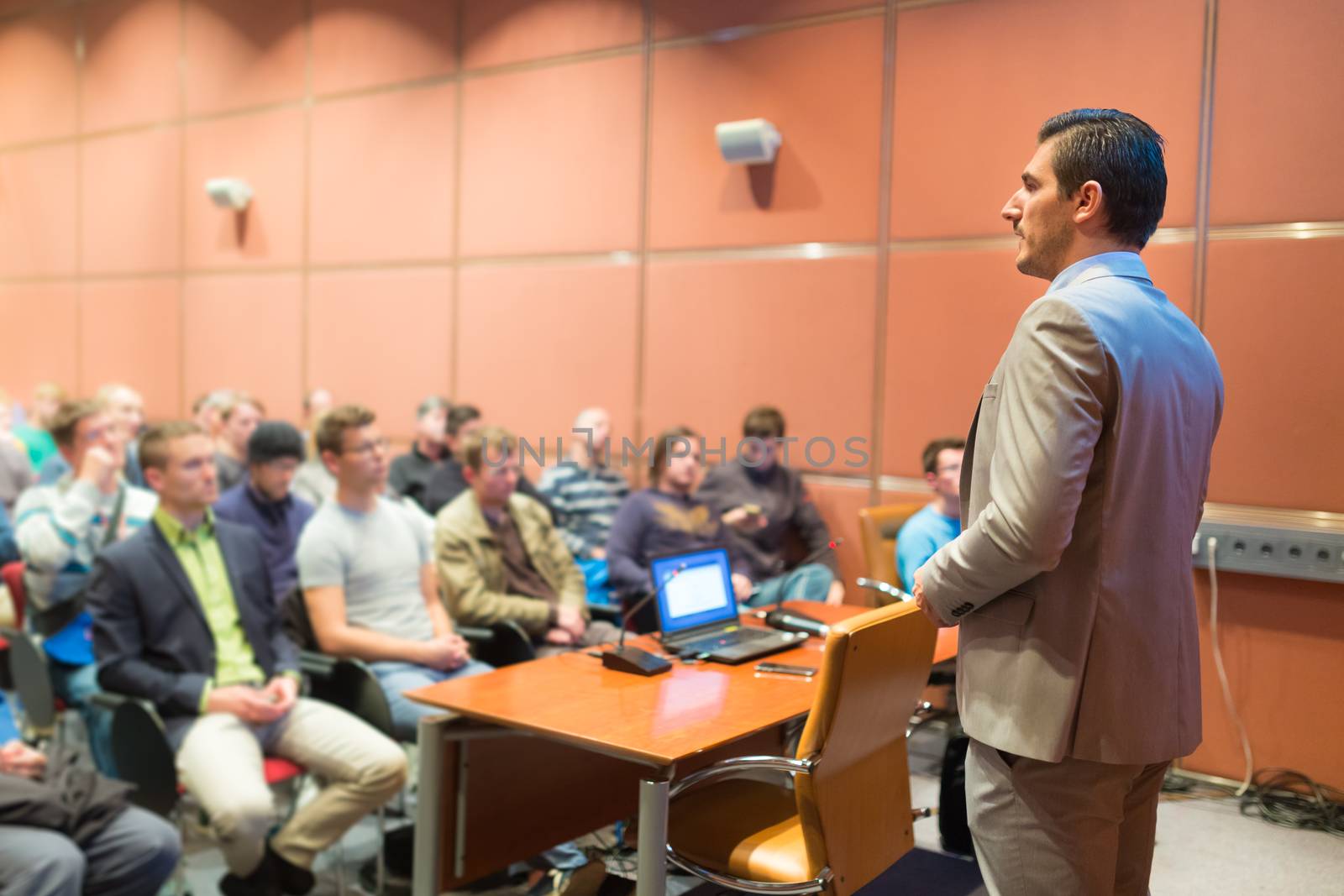 Speaker at Business Conference with Public Presentations. Audience at the conference hall. Business and Entrepreneurship concept. Background blur. Shallow depth of field.