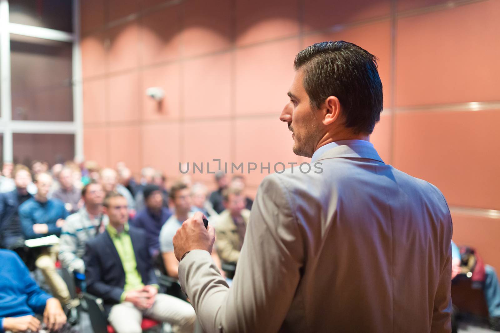 Speaker at Business Conference with Public Presentations. Audience at the conference hall. Business and Entrepreneurship concept. Background blur. Shallow depth of field.