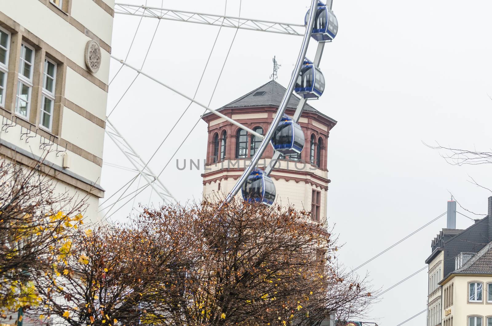 View of a Ferris wheel in the old town of Düsseldorf. In the background, the Maritime Museum.
