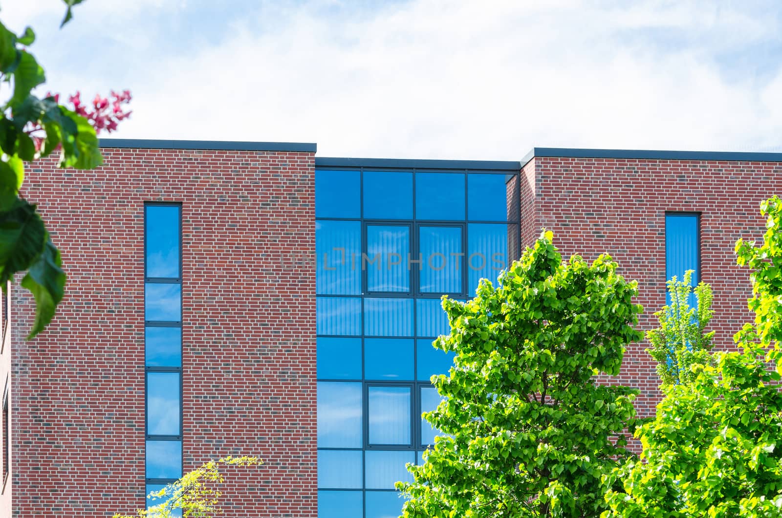 Facade of a modern office building with a large glass front.