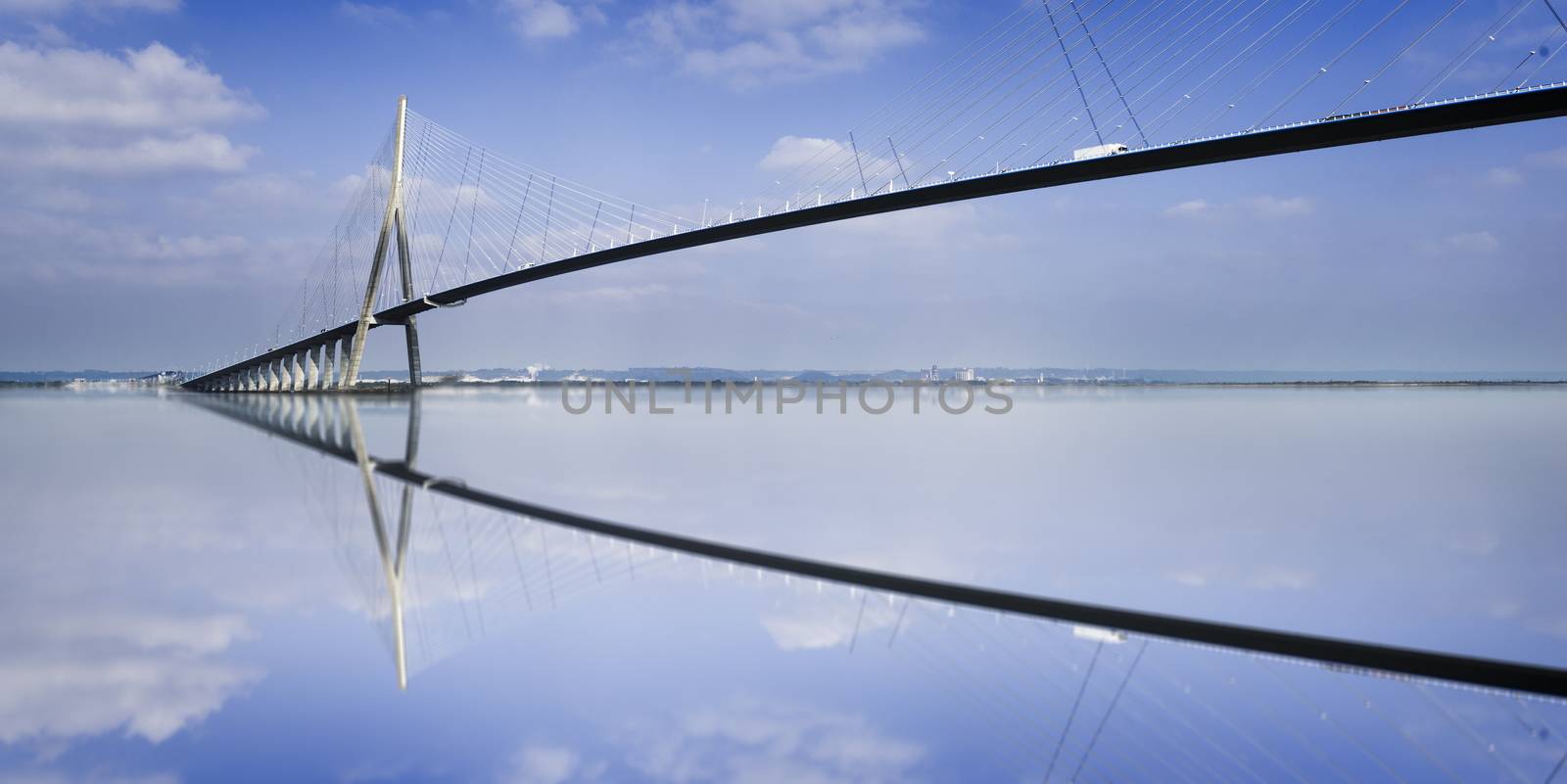 pillar of the bridge "Pont du Normandie" reflected in the Seine river at Le Havre, France