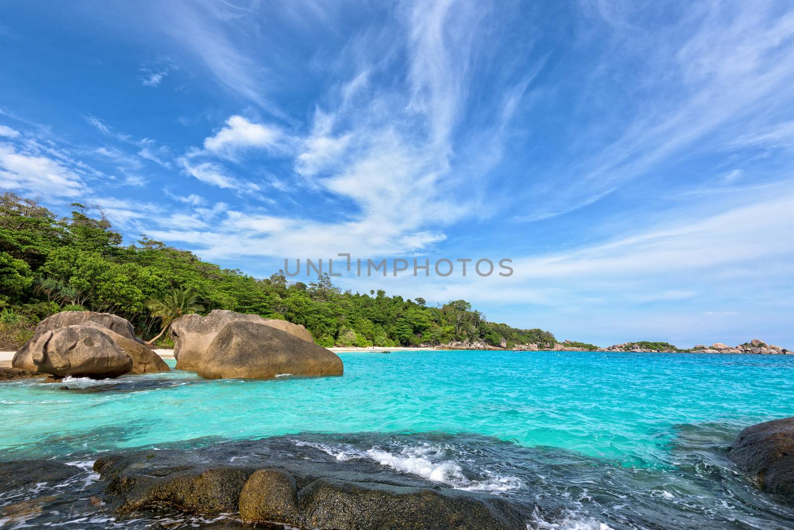 Beautiful landscape of blue sky sea and white waves on beach near the rocks during summer at Koh Miang island in Mu Ko Similan National Park, Phang Nga province, Thailand
