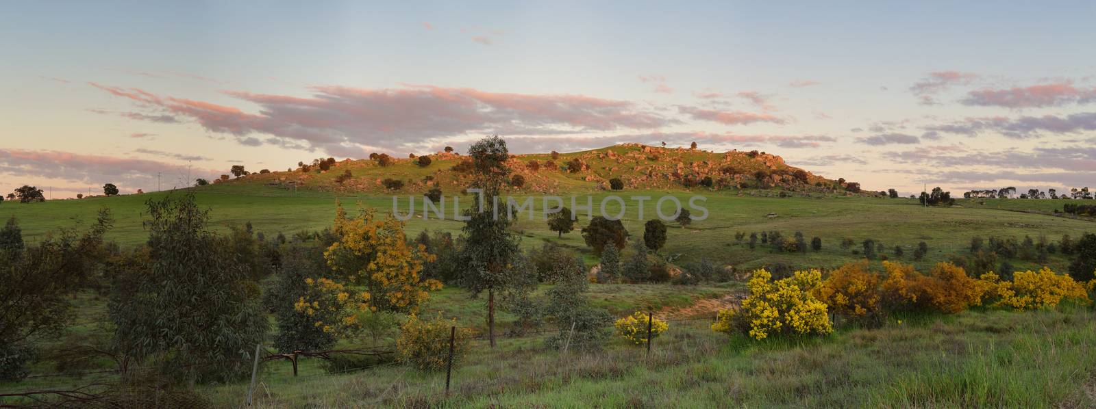 First rays of warm light highlight the hills at Wyangala in Central West NSW Australia