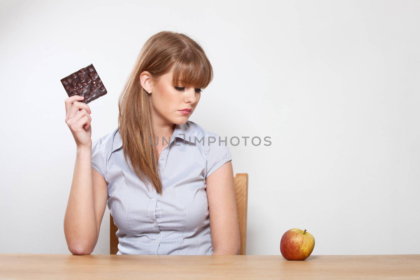 woman with chocolate and an apple