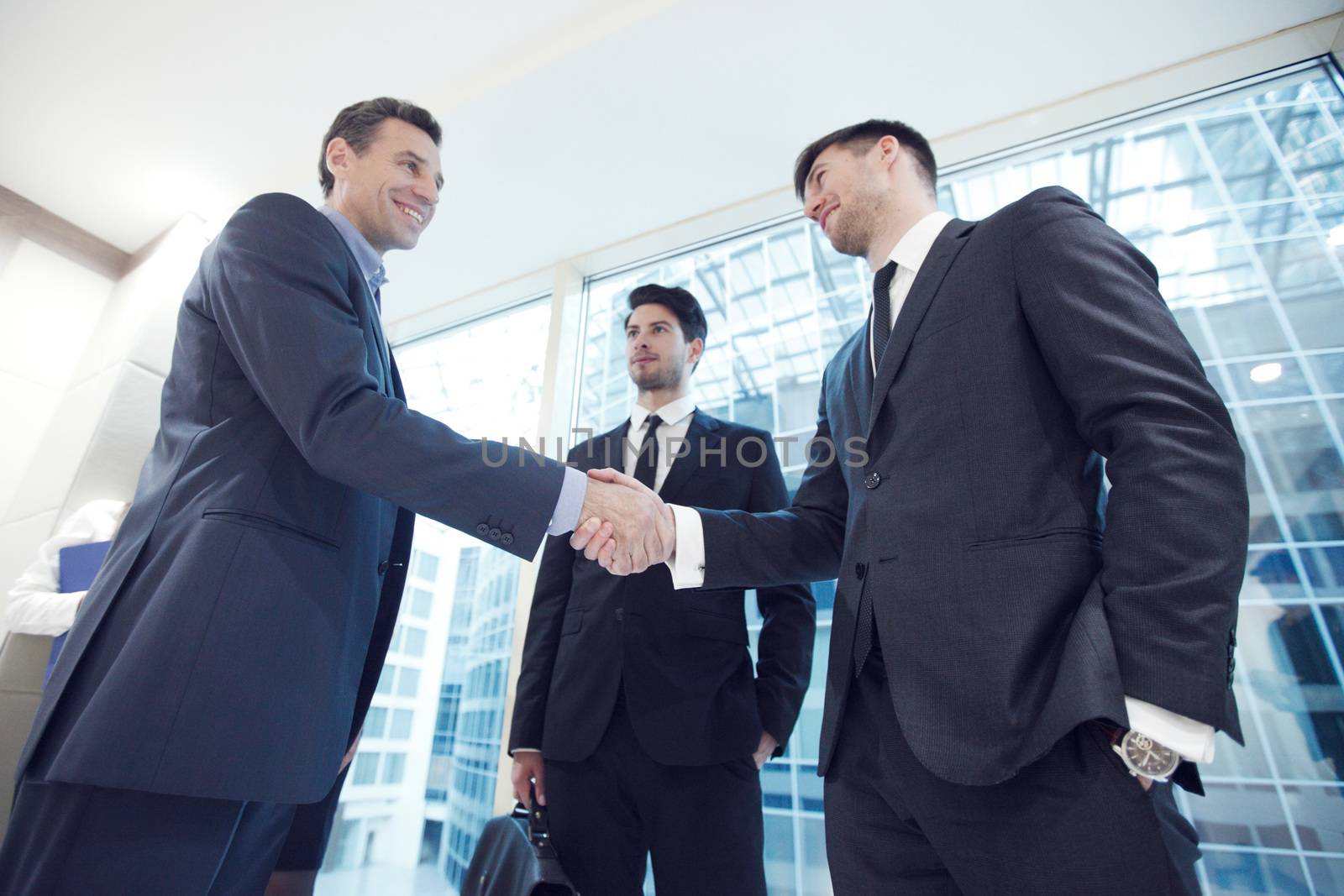 Business people shaking hands by ALotOfPeople